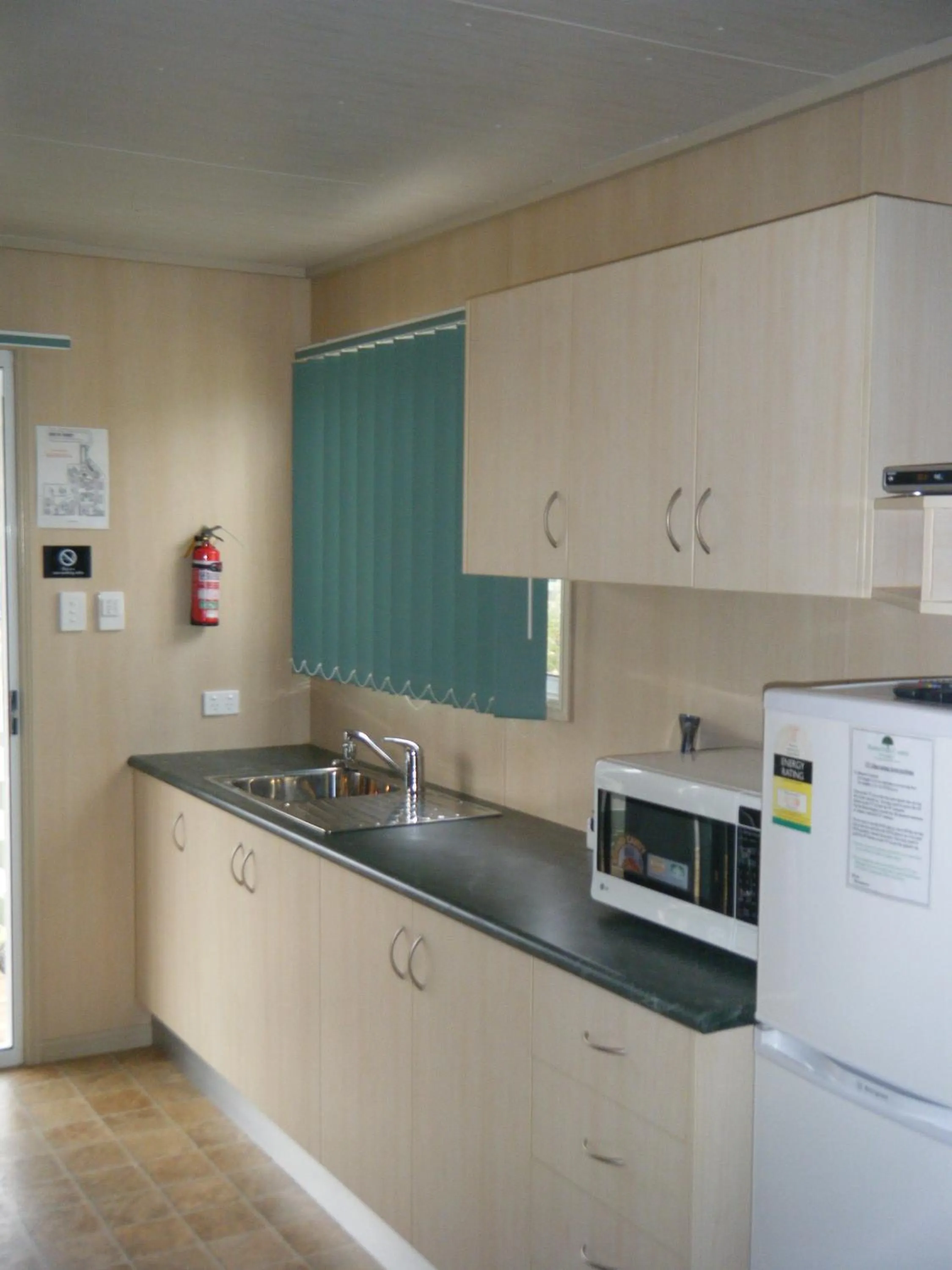 Kitchen or kitchenette in PepperTree Cabins, Kingaroy