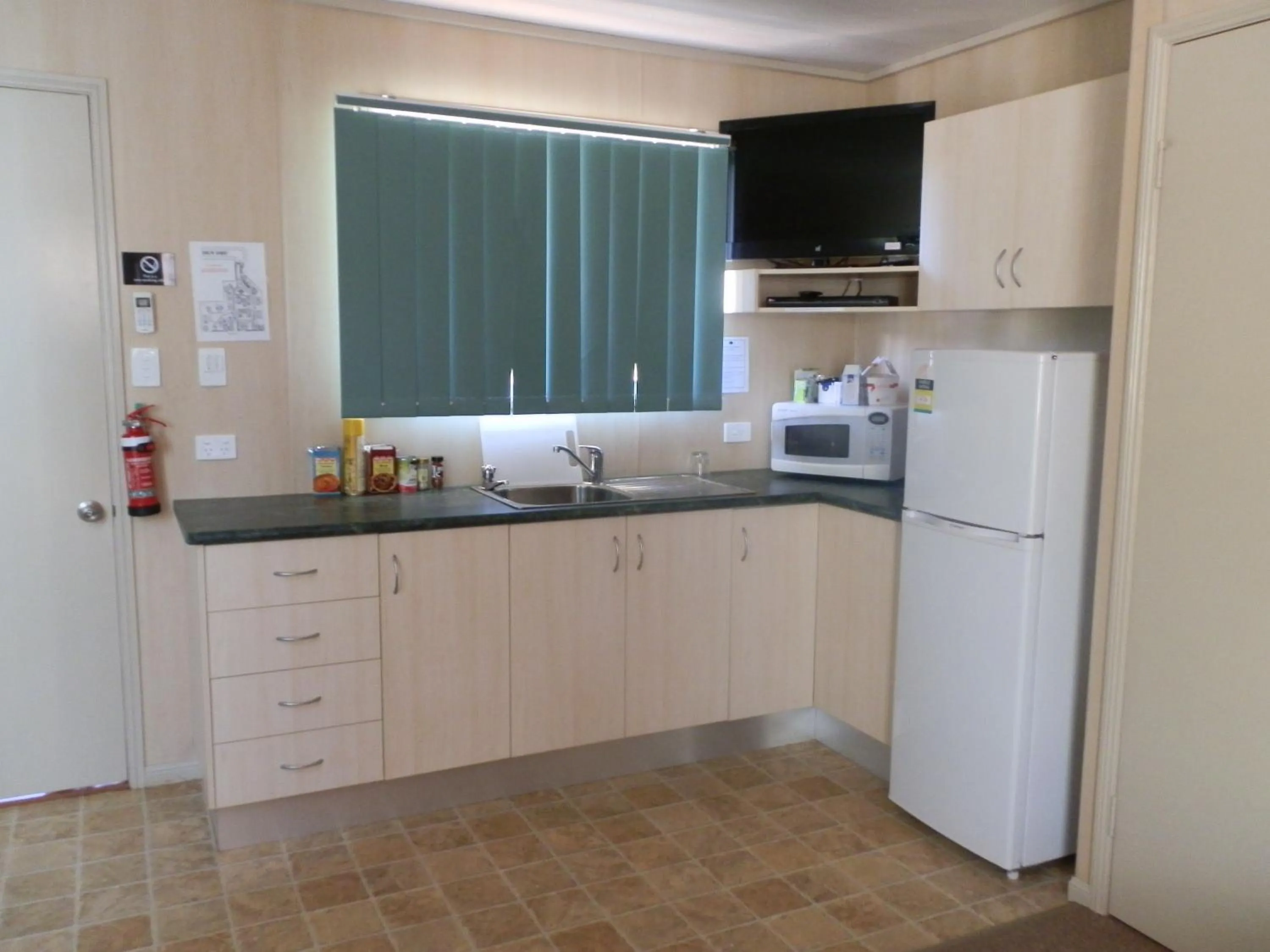 Kitchen or kitchenette in PepperTree Cabins, Kingaroy