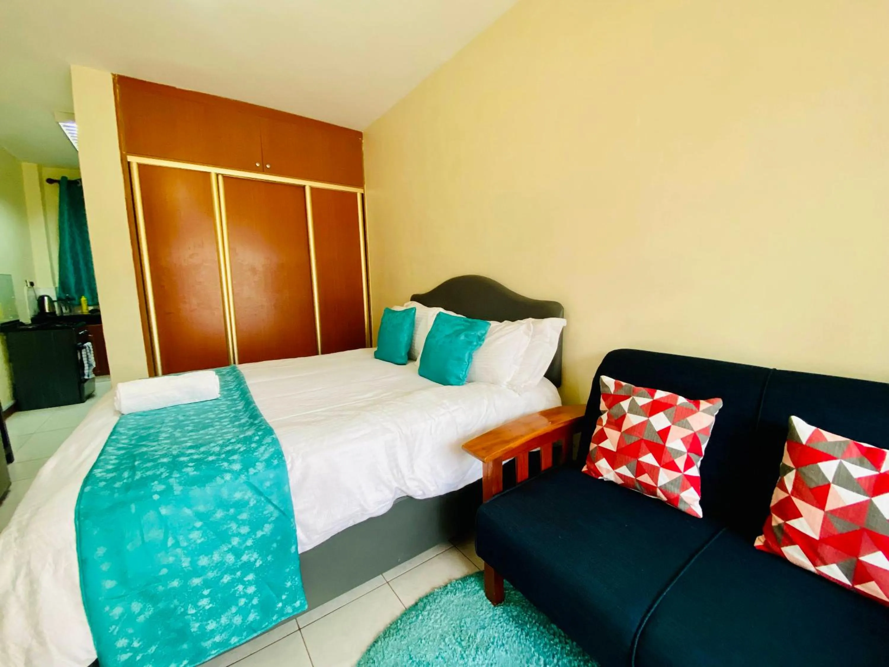 Seating area, Bed in Takdiri Homes