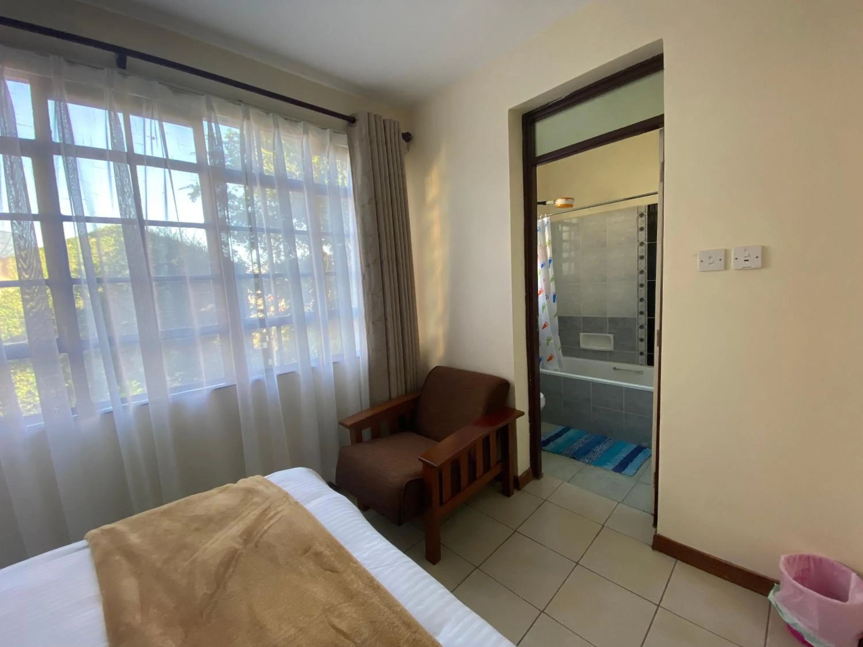 Seating area, Bed in Takdiri Homes