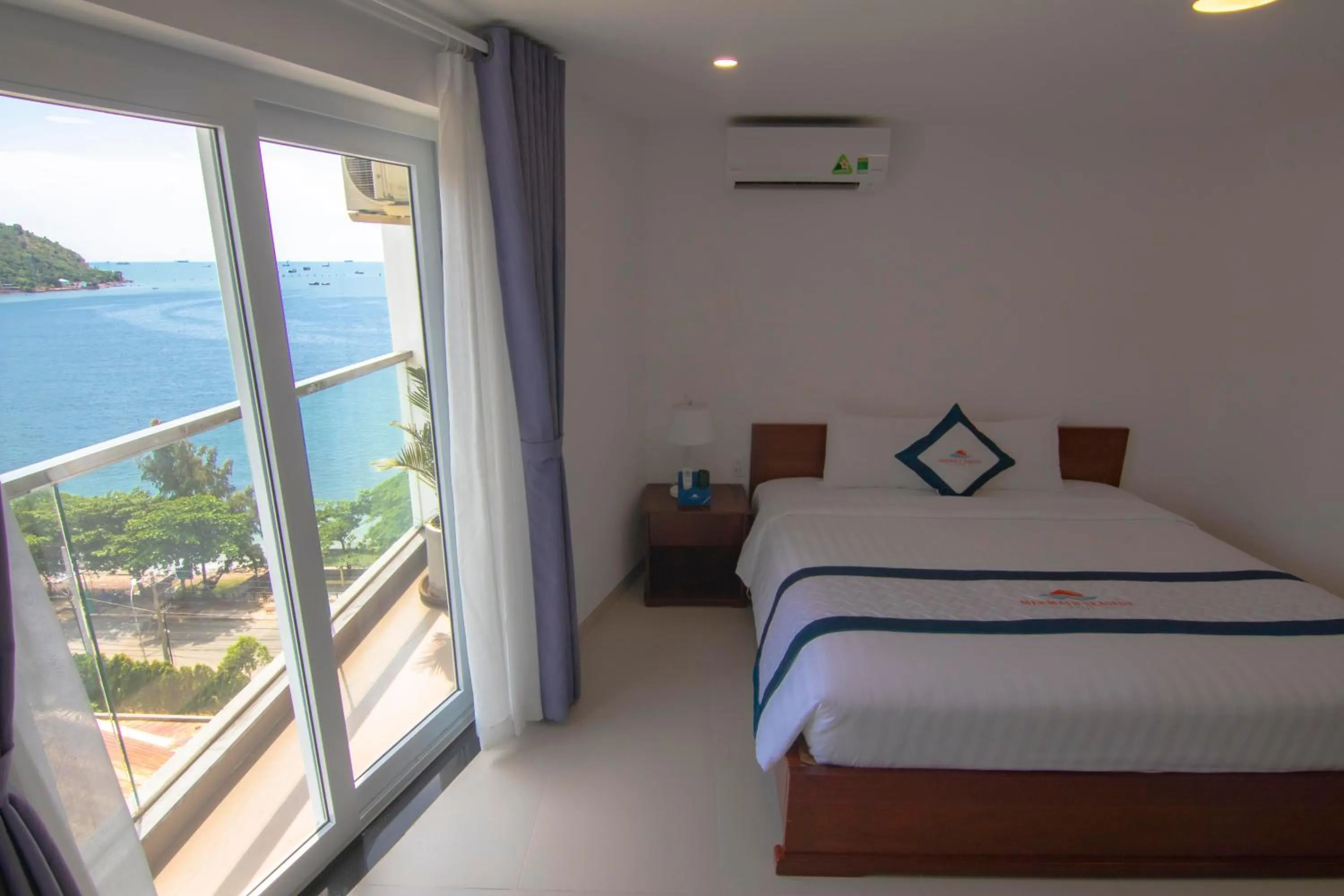 Balcony/Terrace, Bed in Mermaid Seaside Hotel