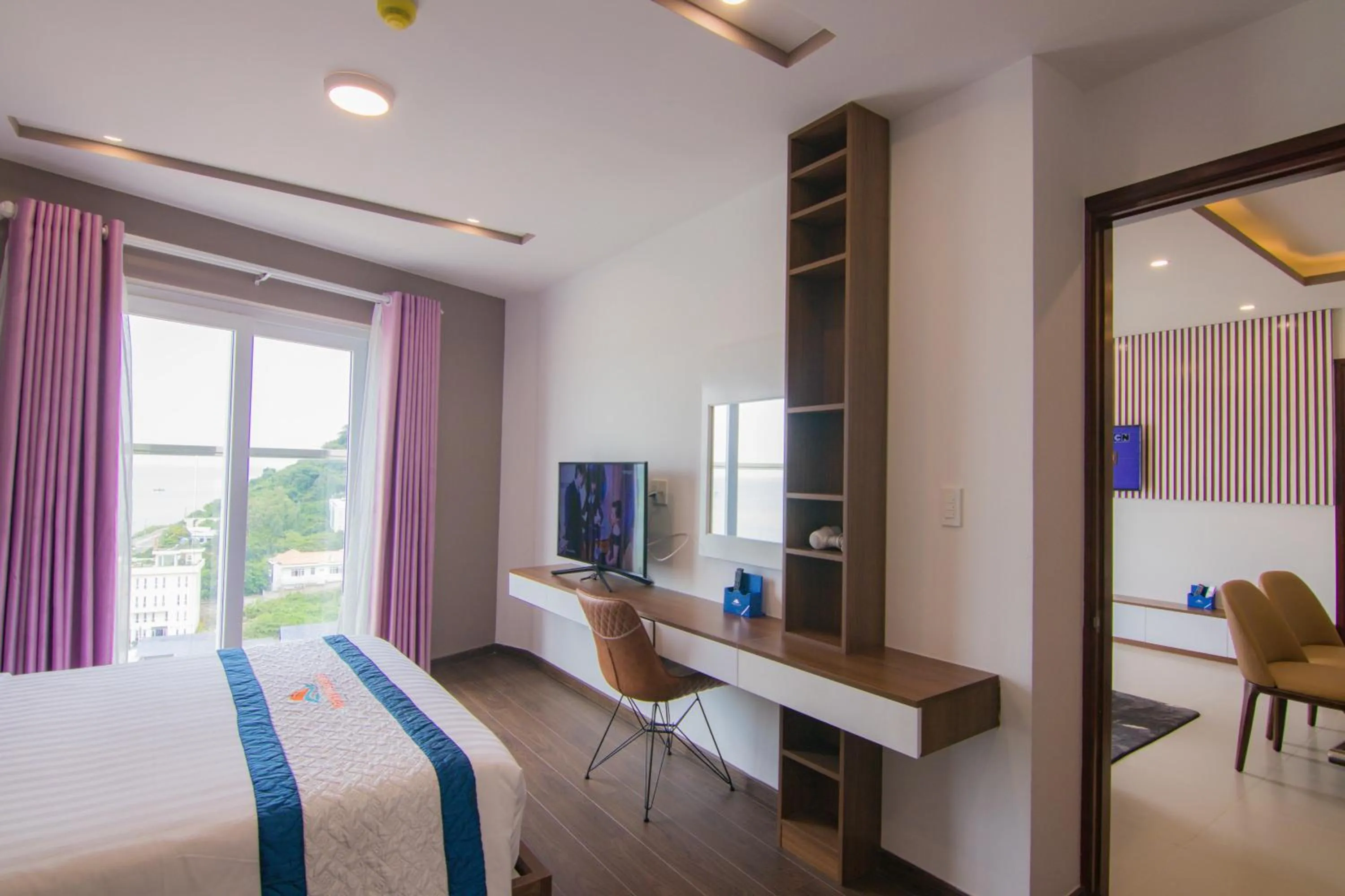 Communal lounge/ TV room, Bed in Mermaid Seaside Hotel