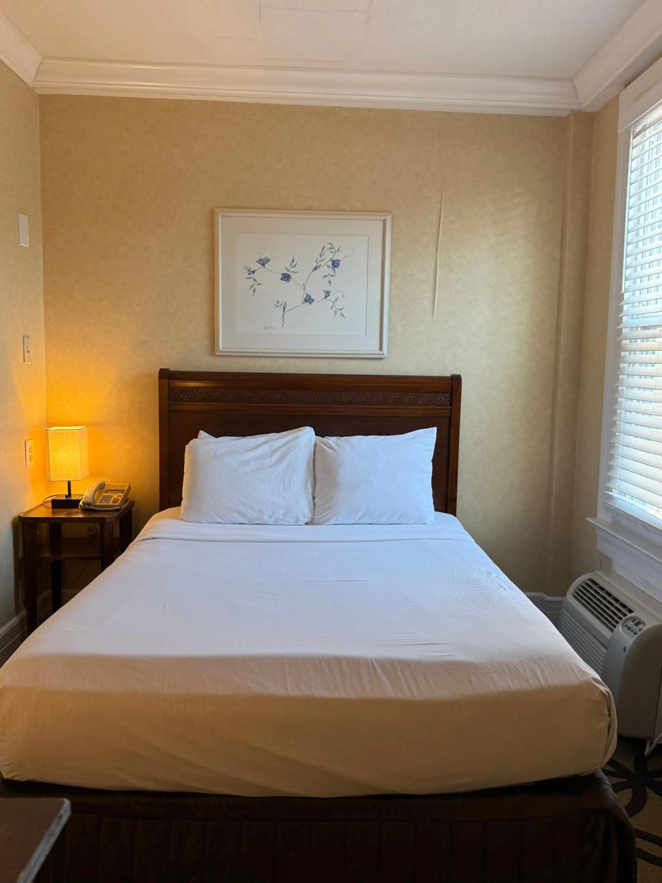 Bed in Windsor Inn Hotel