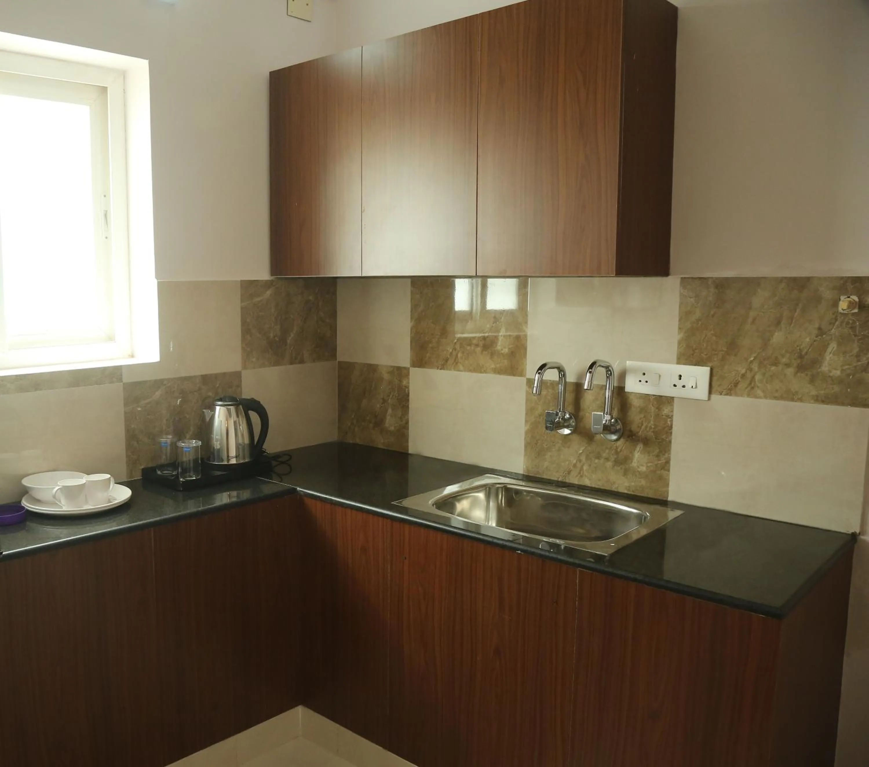 Communal kitchen in Kfour Apartment & Hotels Private Limited