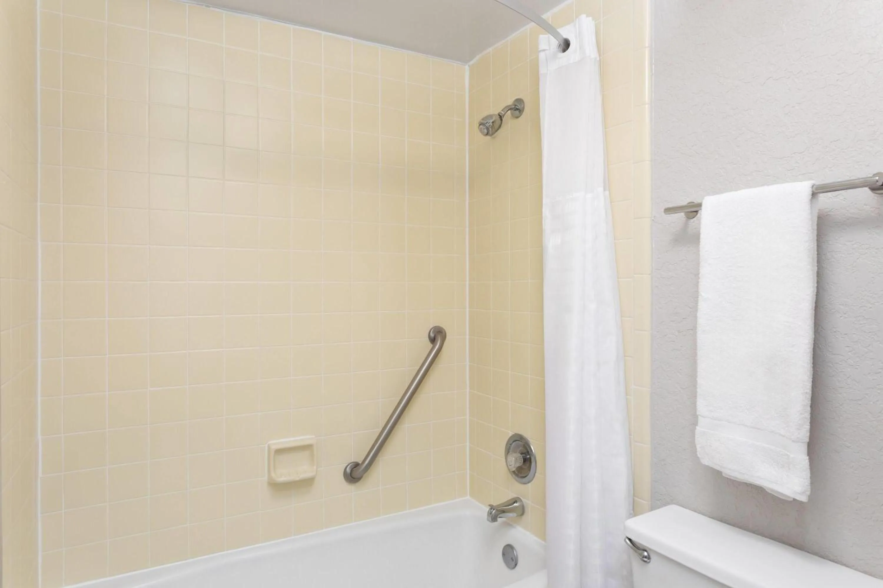 Bathroom in Days Inn by Wyndham Orlando Conv. Center/International Dr