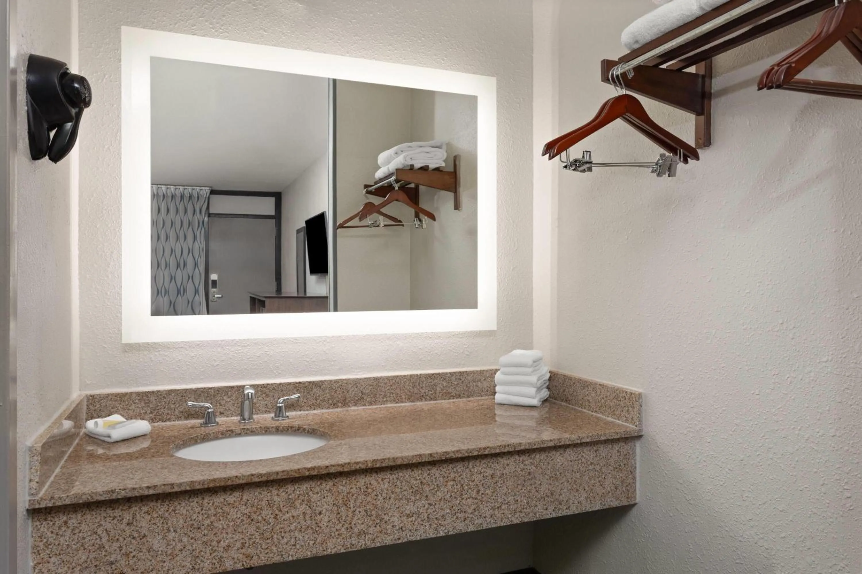 Bathroom in Days Inn by Wyndham Orlando Conv. Center/International Dr