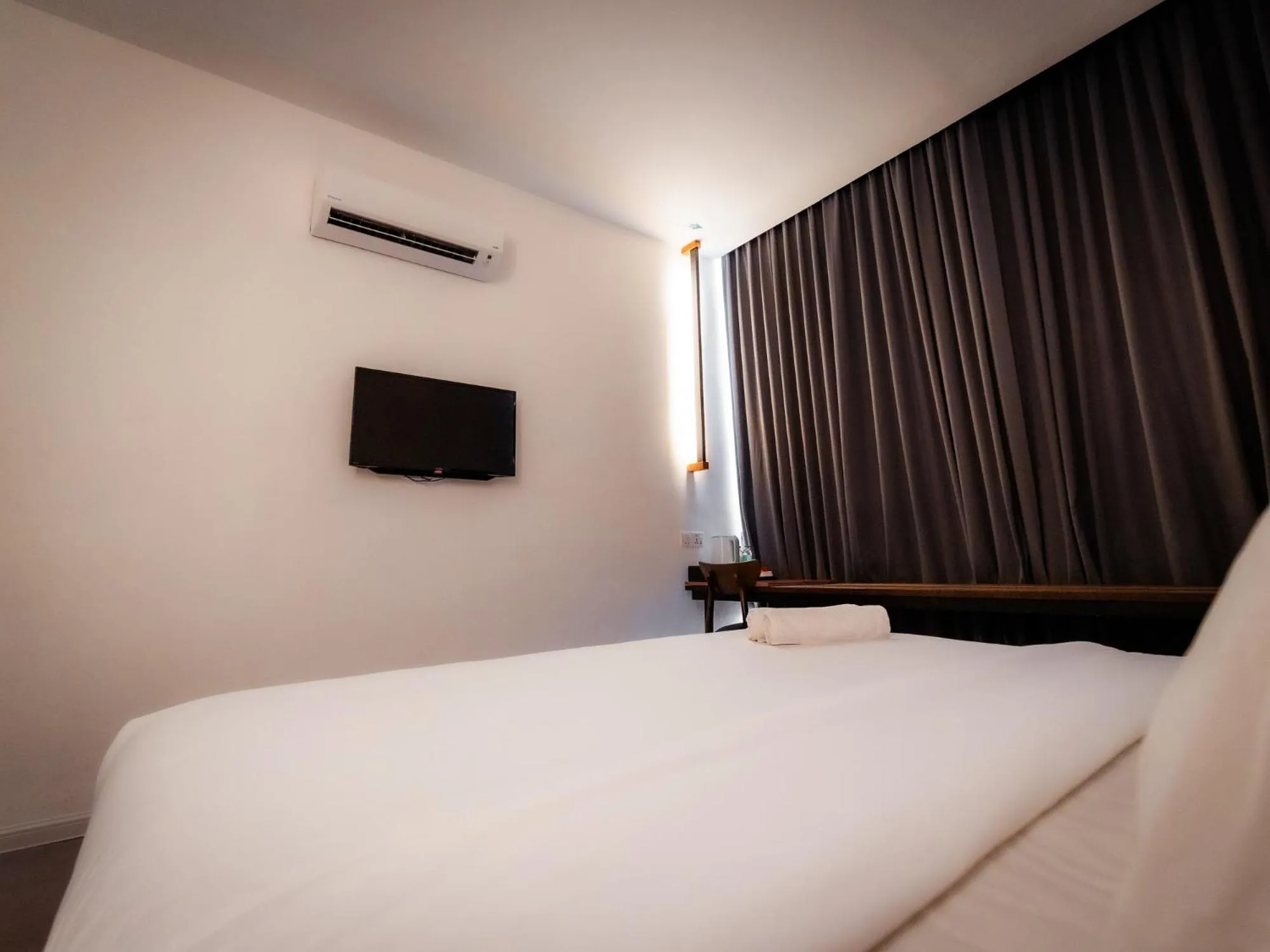 Bed in T+ PREMIUM HOTEL