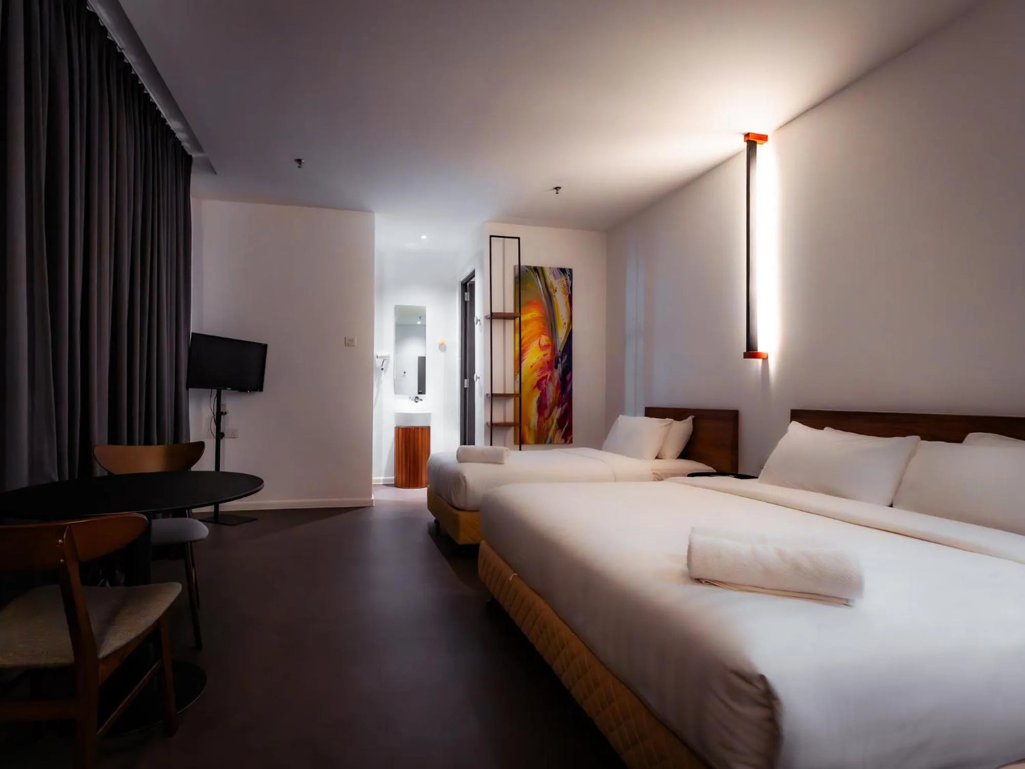 Bed in T+ PREMIUM HOTEL