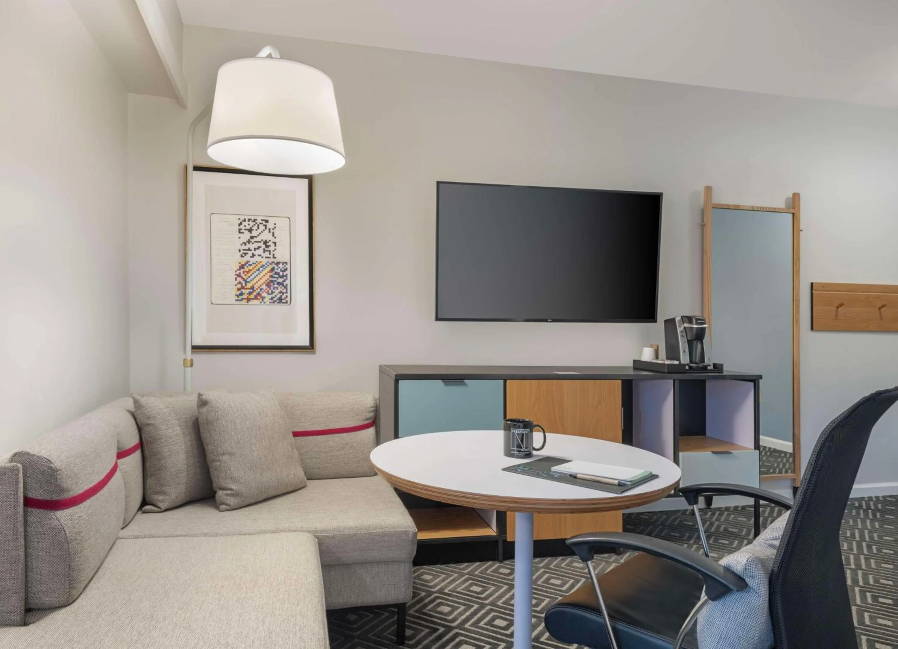 Living room in Freepoint Hotel Cambridge, Tapestry Collection by Hilton