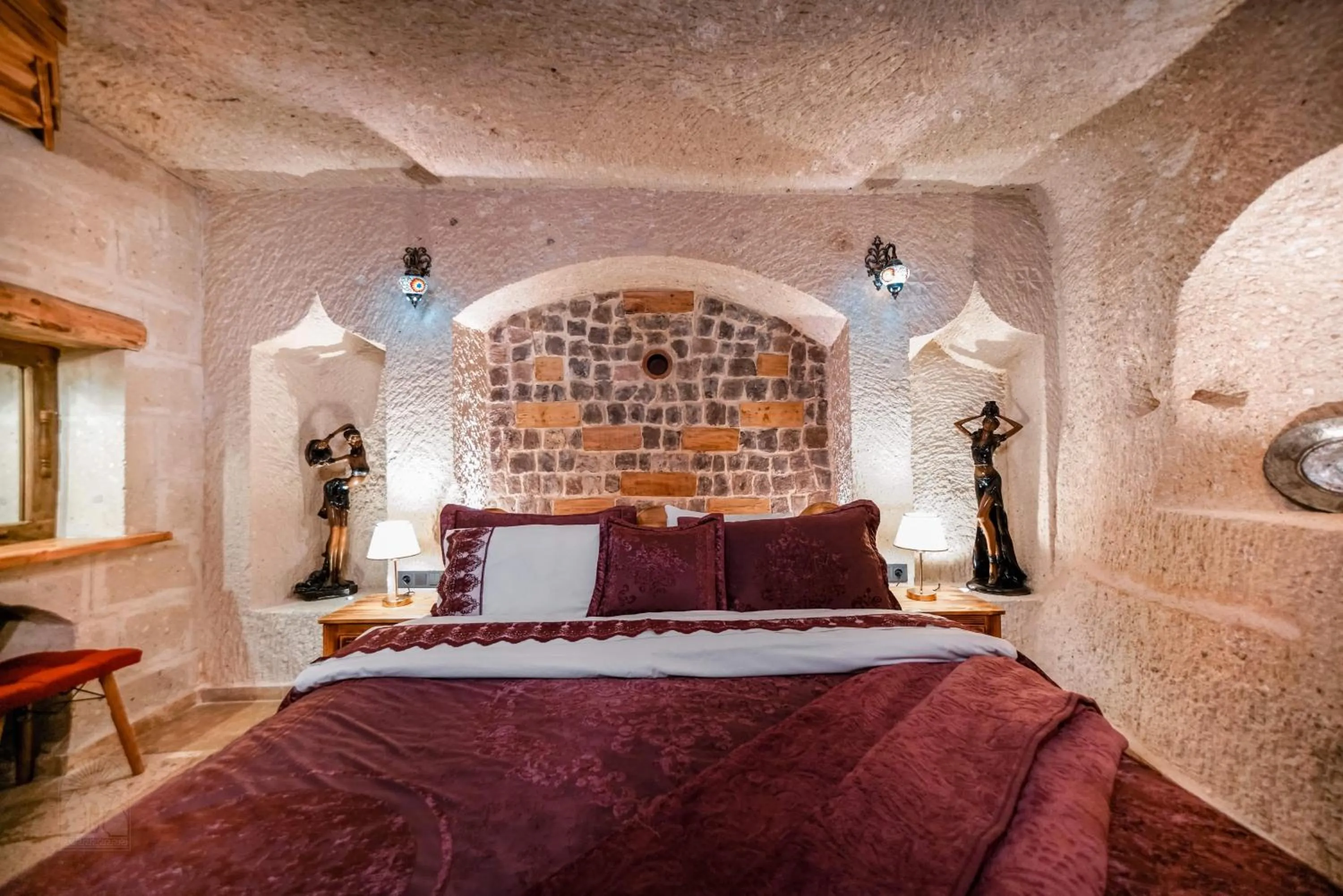 Bed in Zeus Cave Suites