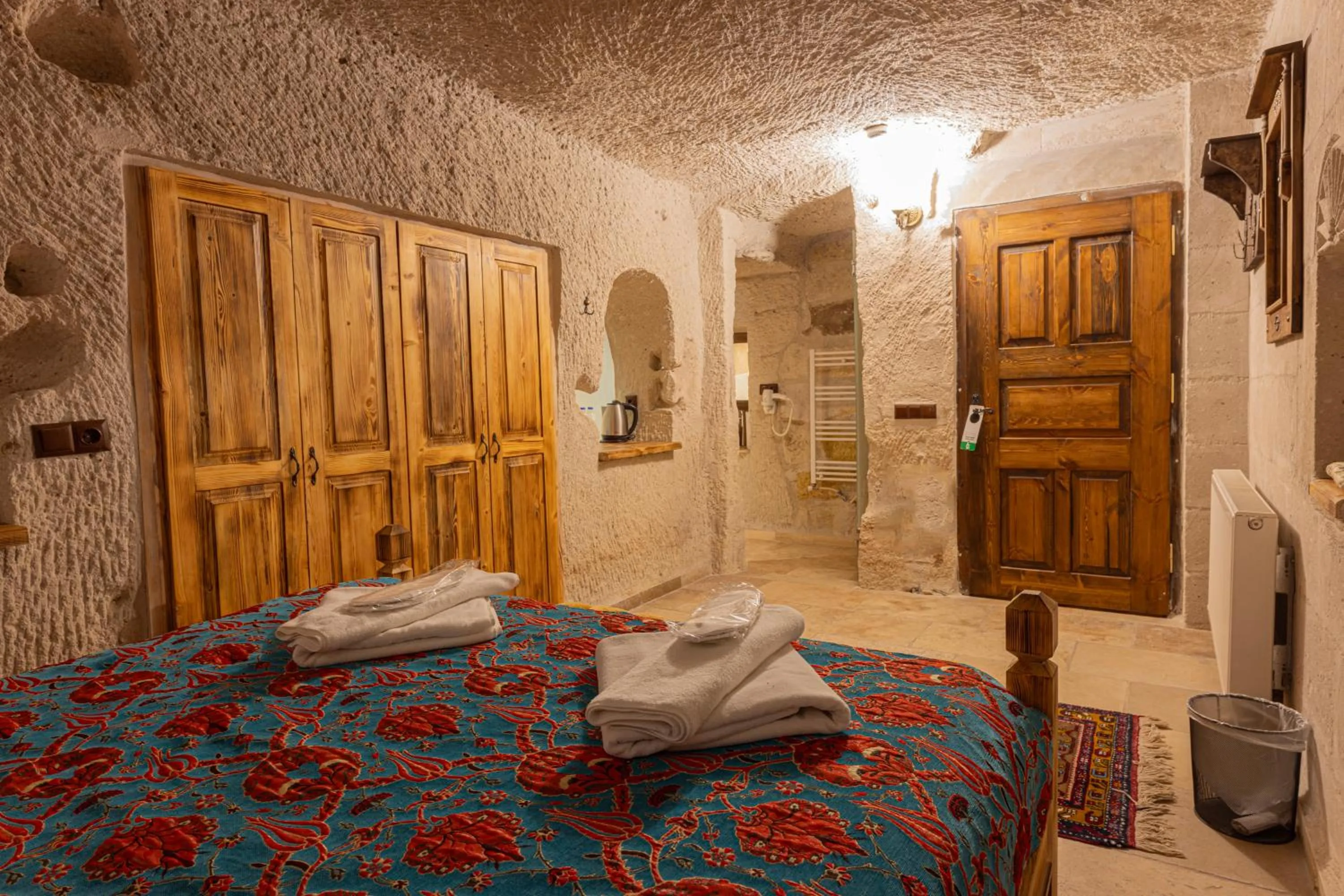Bed in Zeus Cave Suites