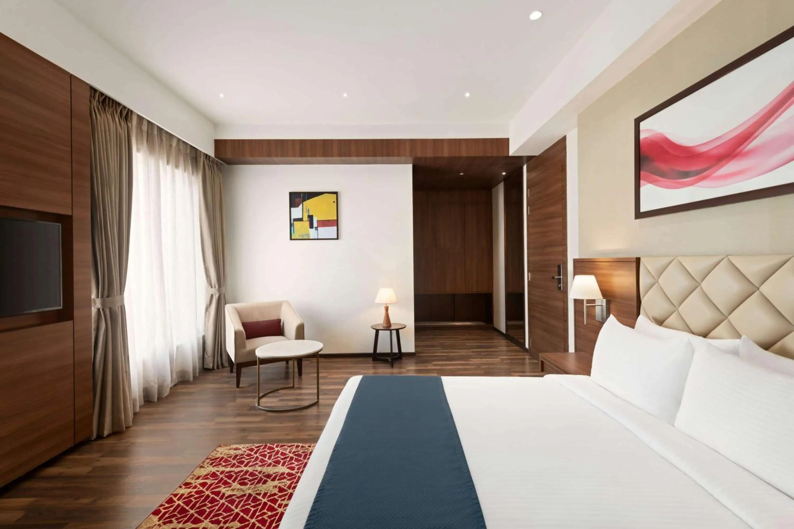 Photo of the whole room, Bed in Ramada by Wyndham Gandhidham Shinay