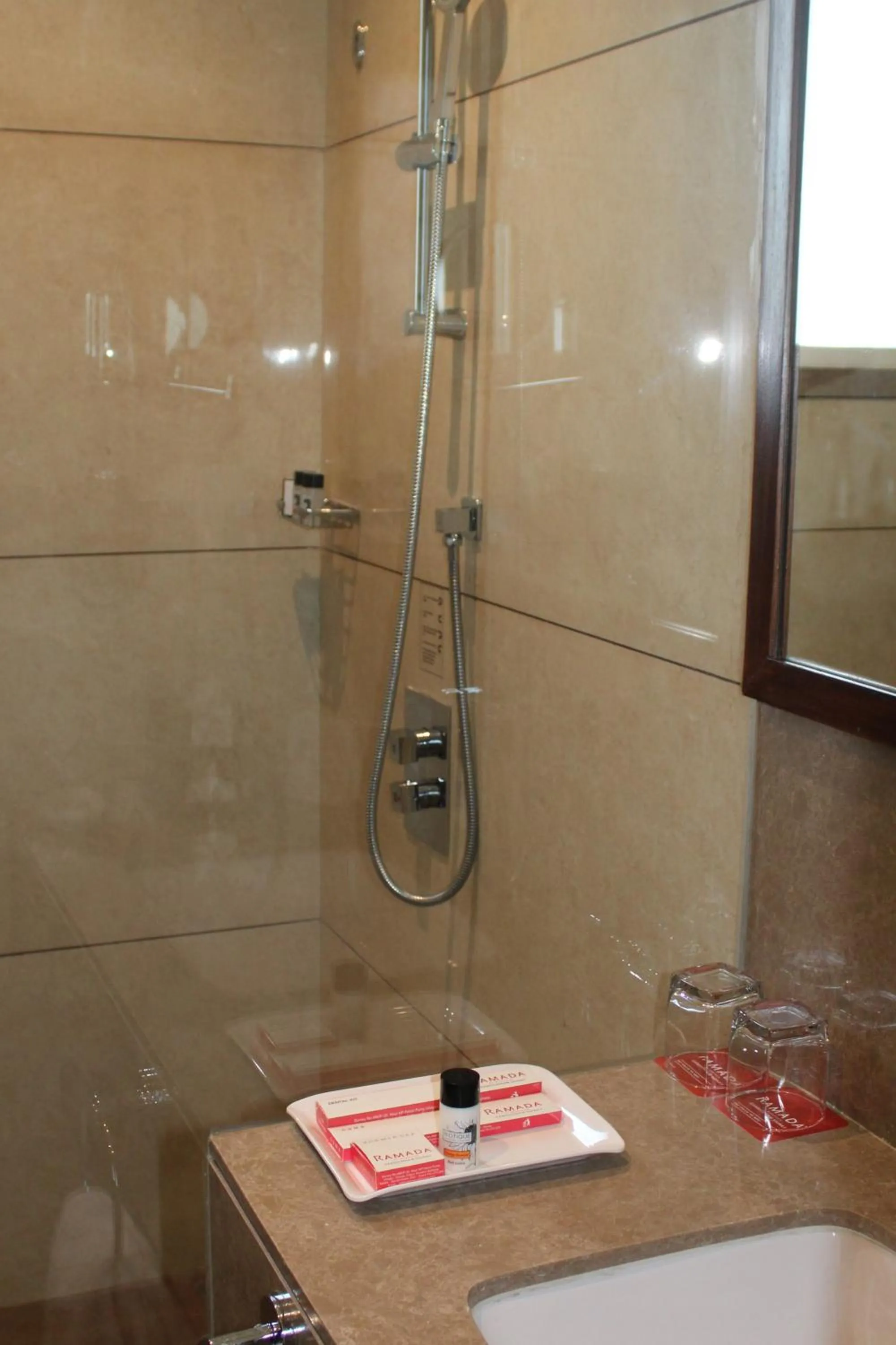 Shower in Ramada by Wyndham Gandhidham Shinay