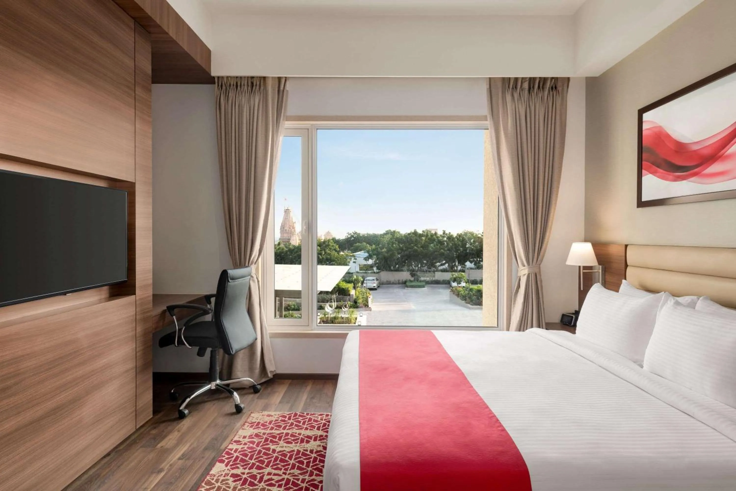 Photo of the whole room, Bed in Ramada by Wyndham Gandhidham Shinay