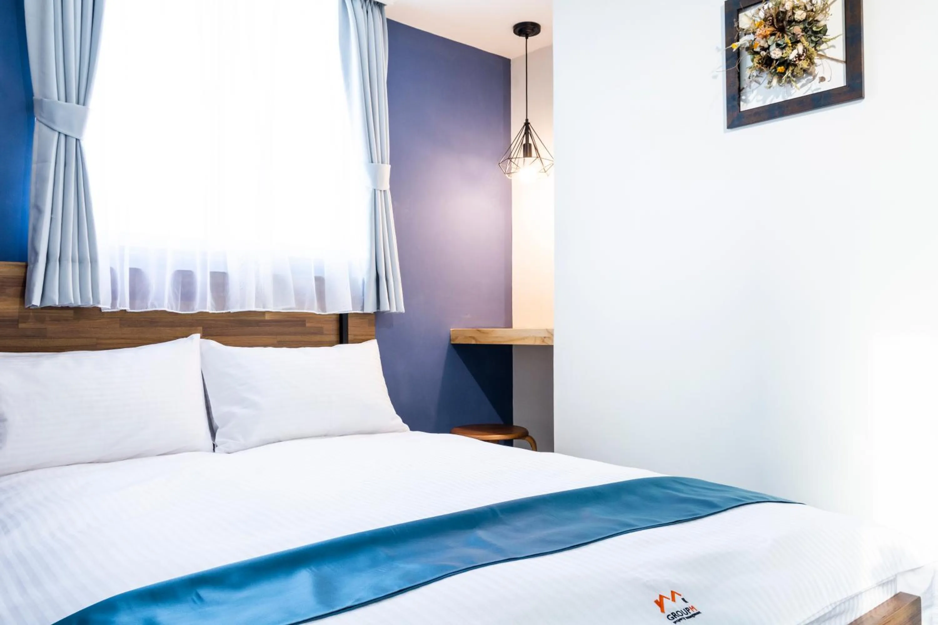 Bed in 沐藍輕旅 Mulan Light Inn I 海安路住宿