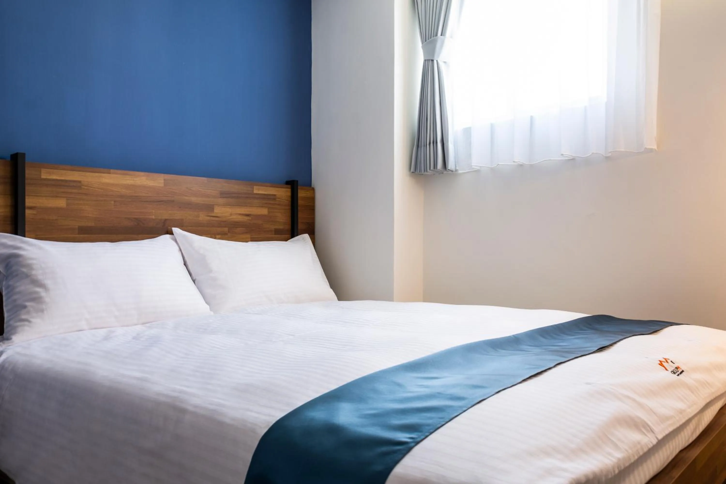 Bed in 沐藍輕旅 Mulan Light Inn I 海安路住宿