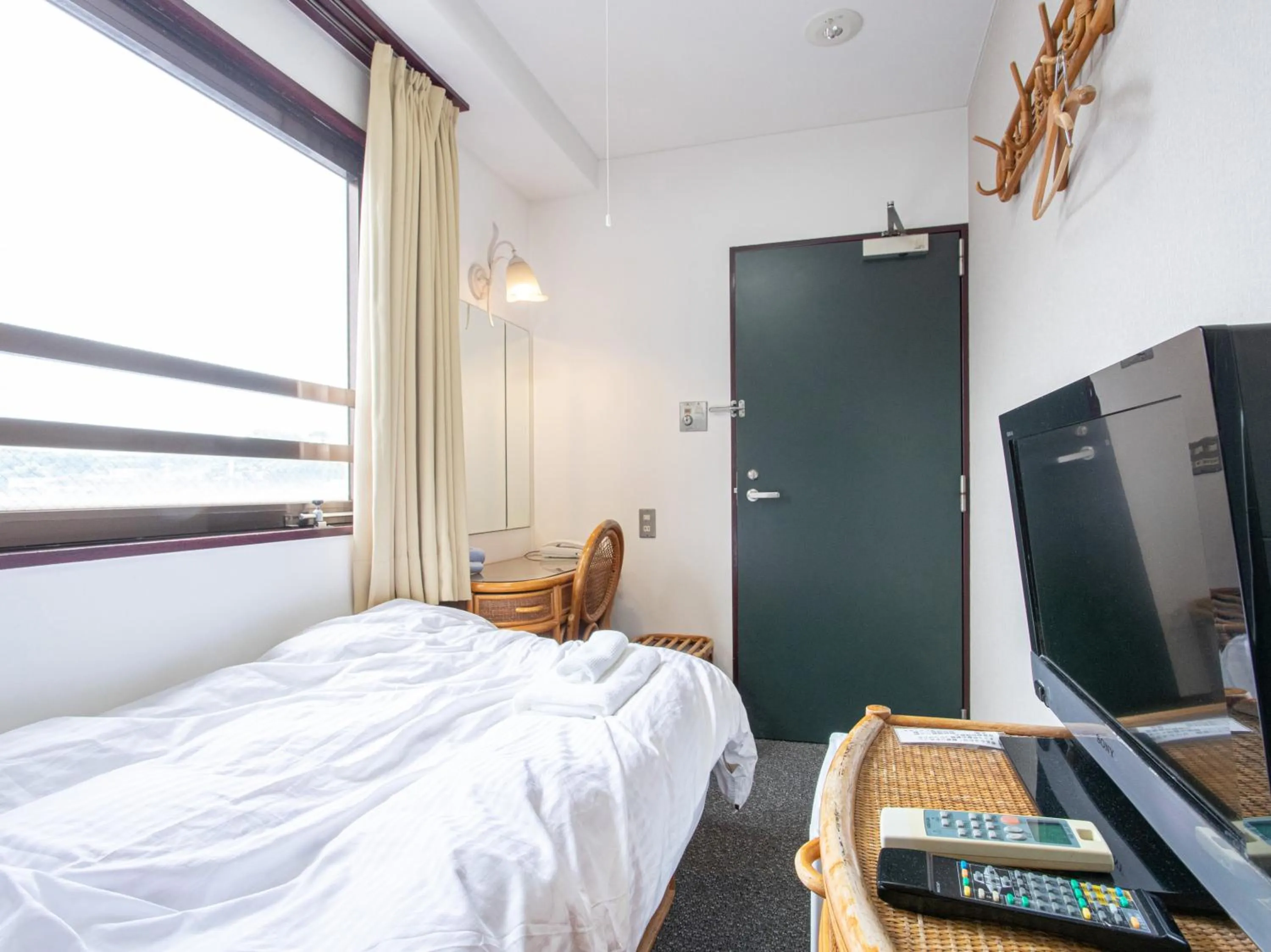 Photo of the whole room, Bed in Tabist New World Hotel Kagoshima Kanoya