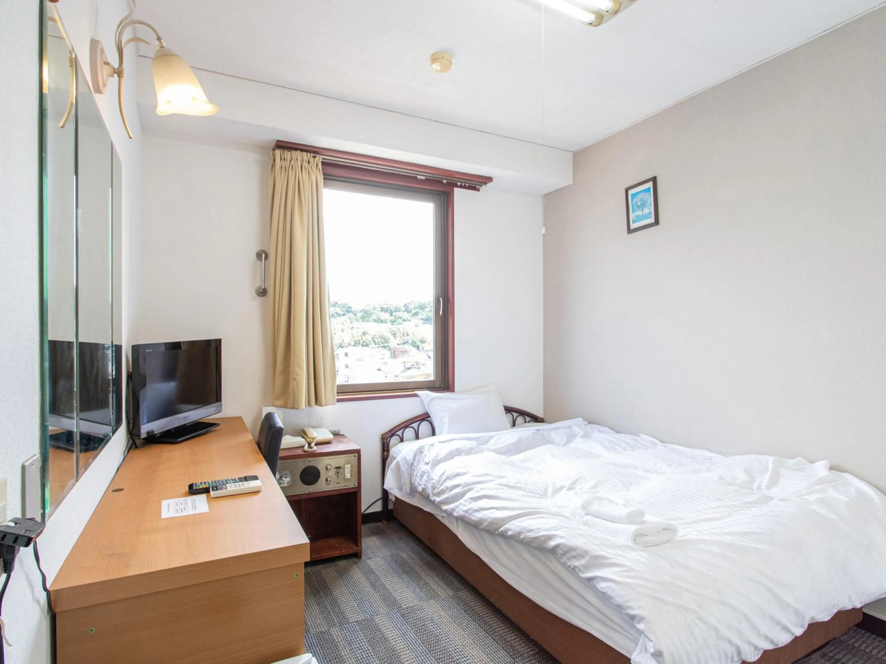 Photo of the whole room, Bed in Tabist New World Hotel Kagoshima Kanoya