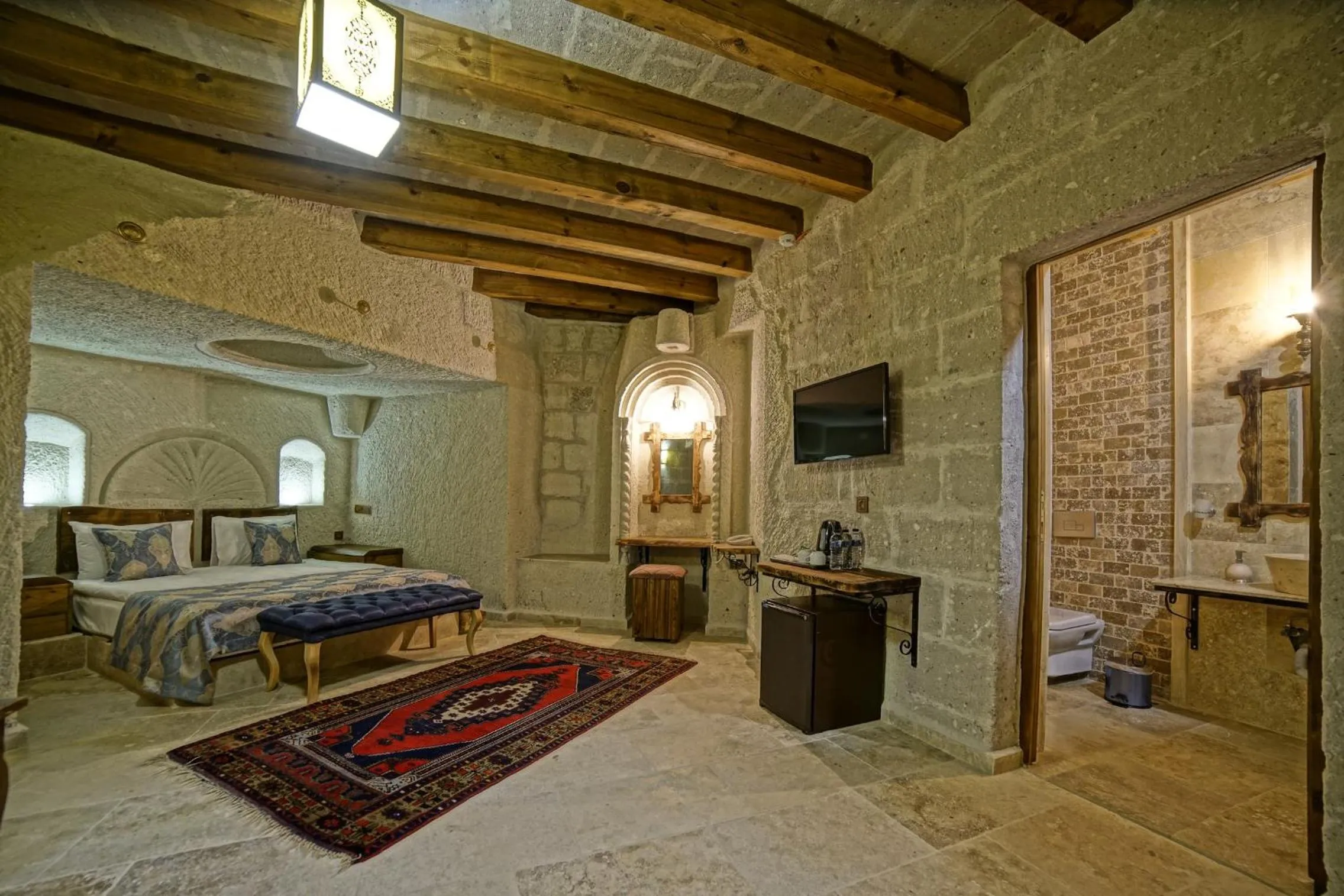 Bed in Risus Cave Suites