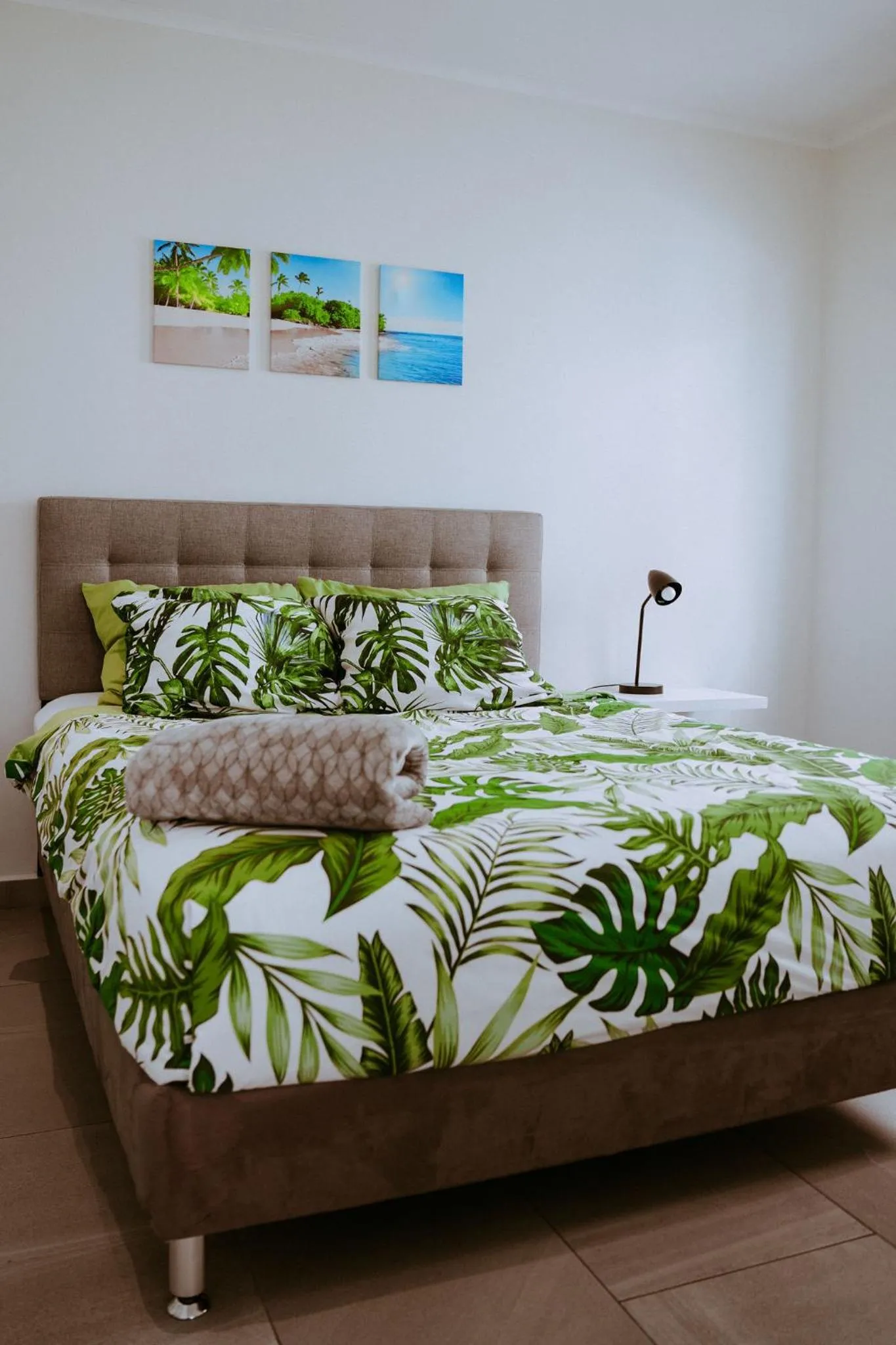 Bed in The Palm Leaf Apartments