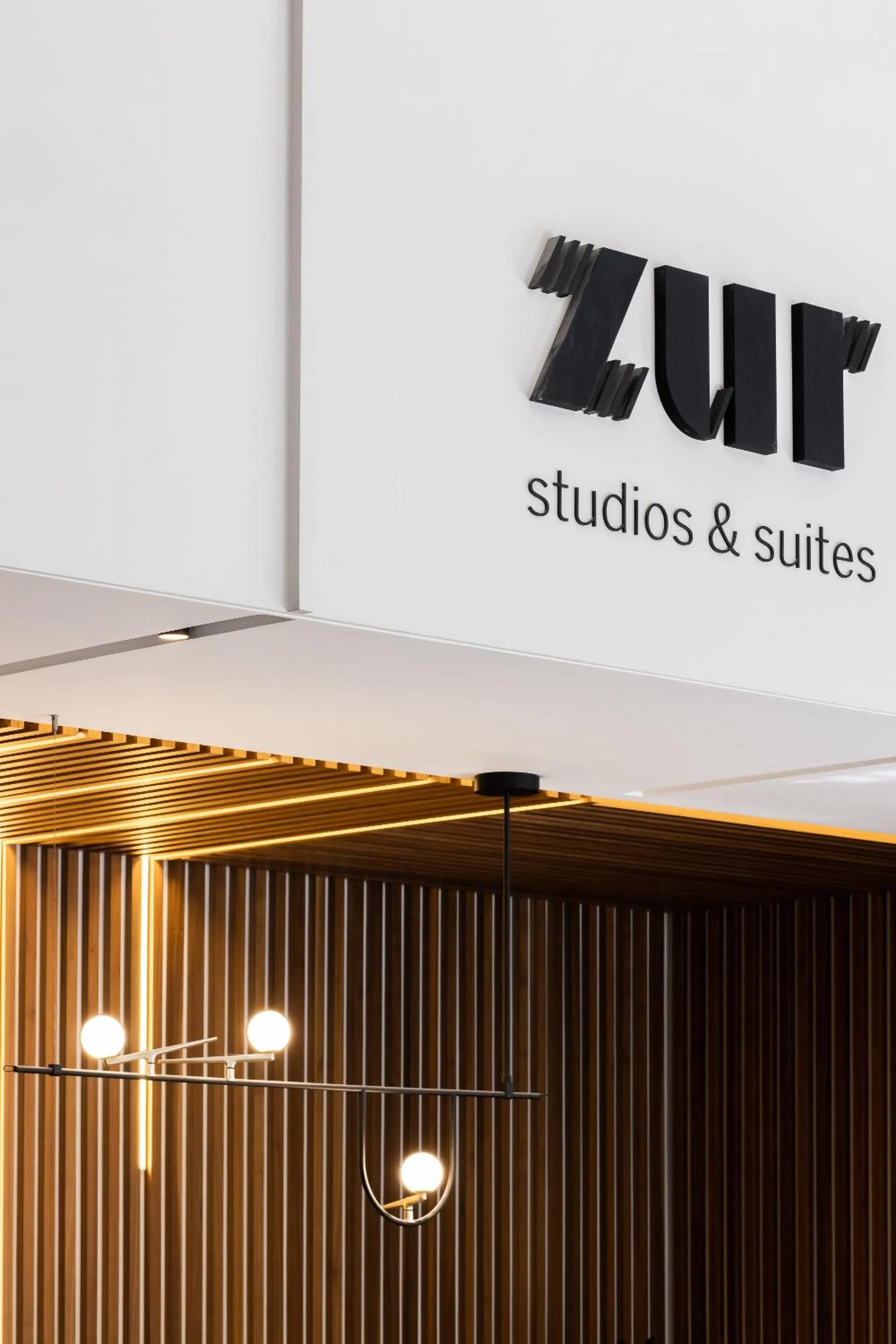 Property logo or sign in ZUR Studios and Suites