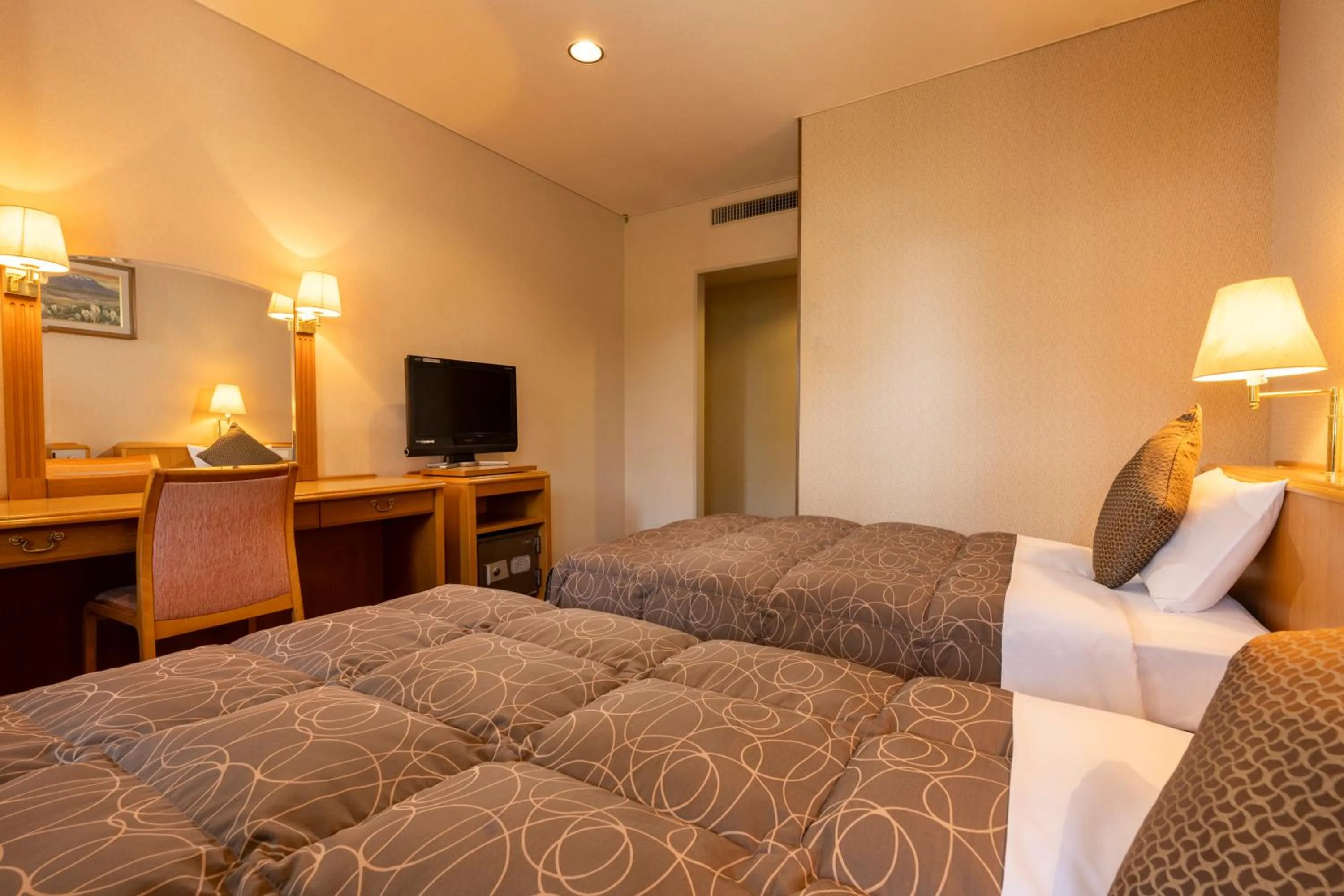 Bed in KAMENOI HOTEL Fukui