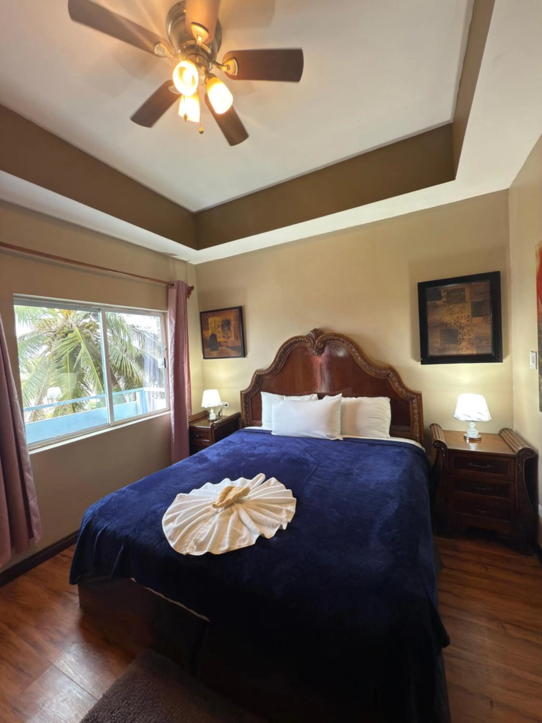 Bed in Hotel Royal Blue & Golf Cart Rental