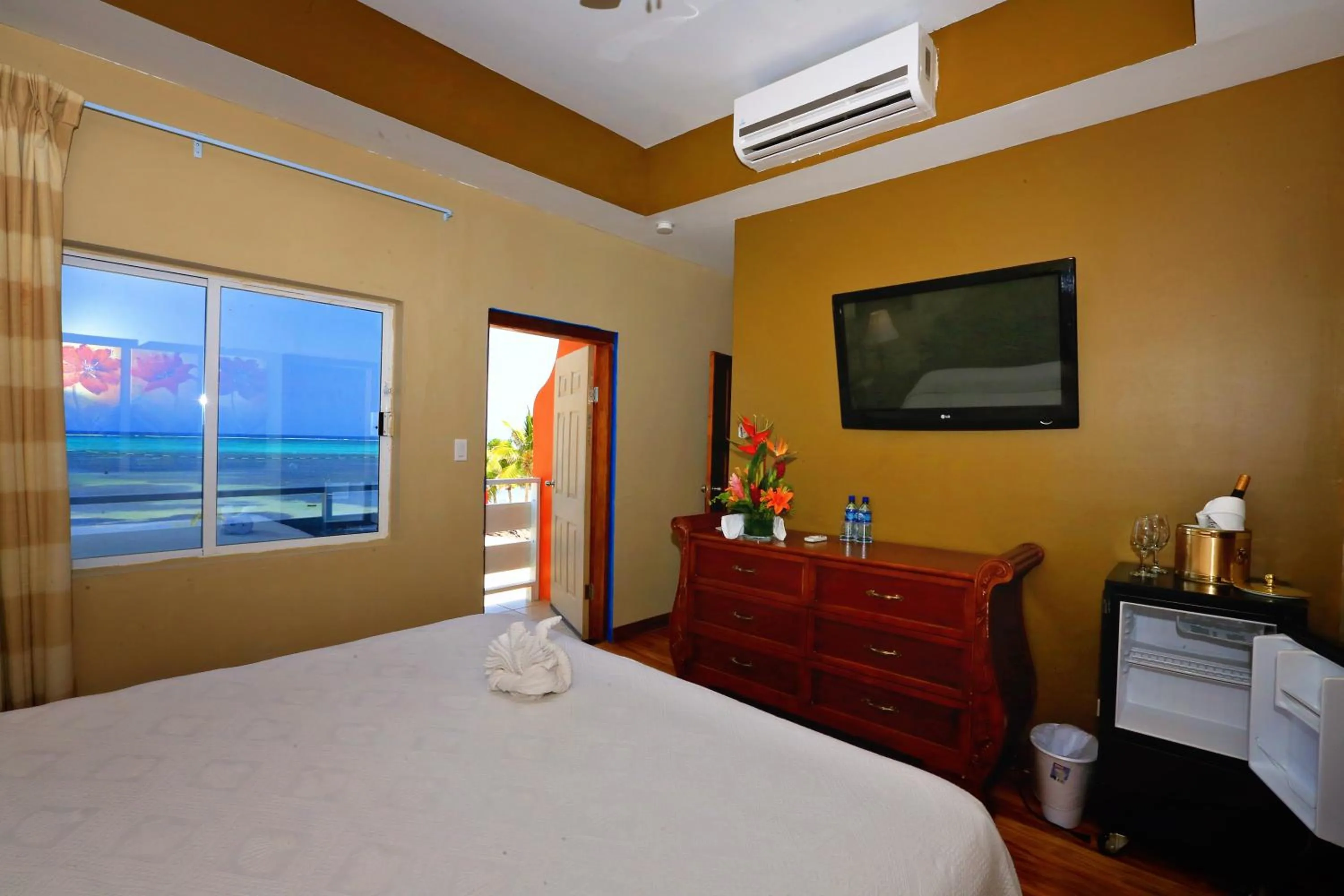 Bed in Hotel Royal Blue & Golf Cart Rental