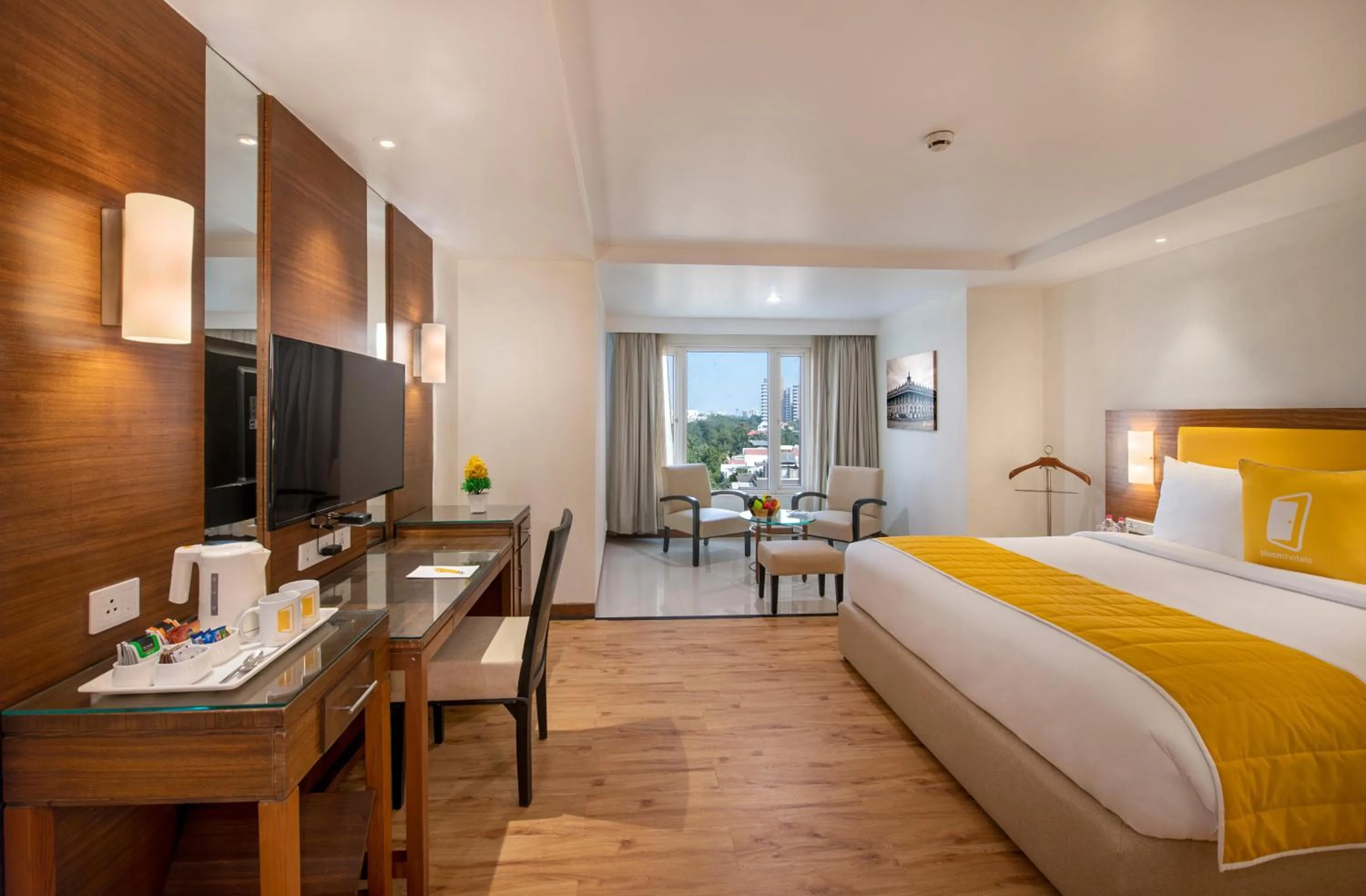 Photo of the whole room, Bed in BloomSuites l Ahmedabad