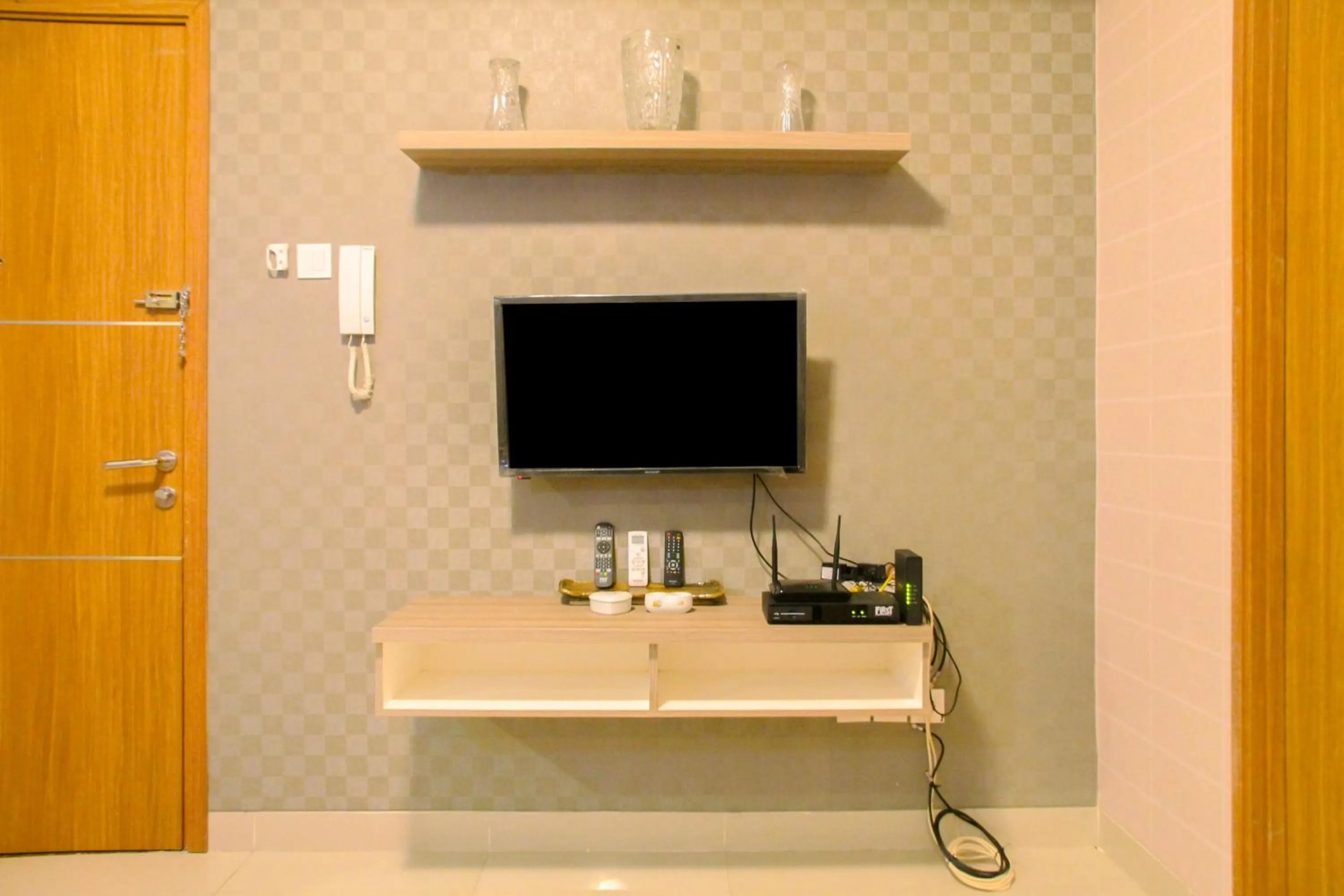 Living room in Best Price 1BR Apartment at The Oasis Cikarang By Travelio