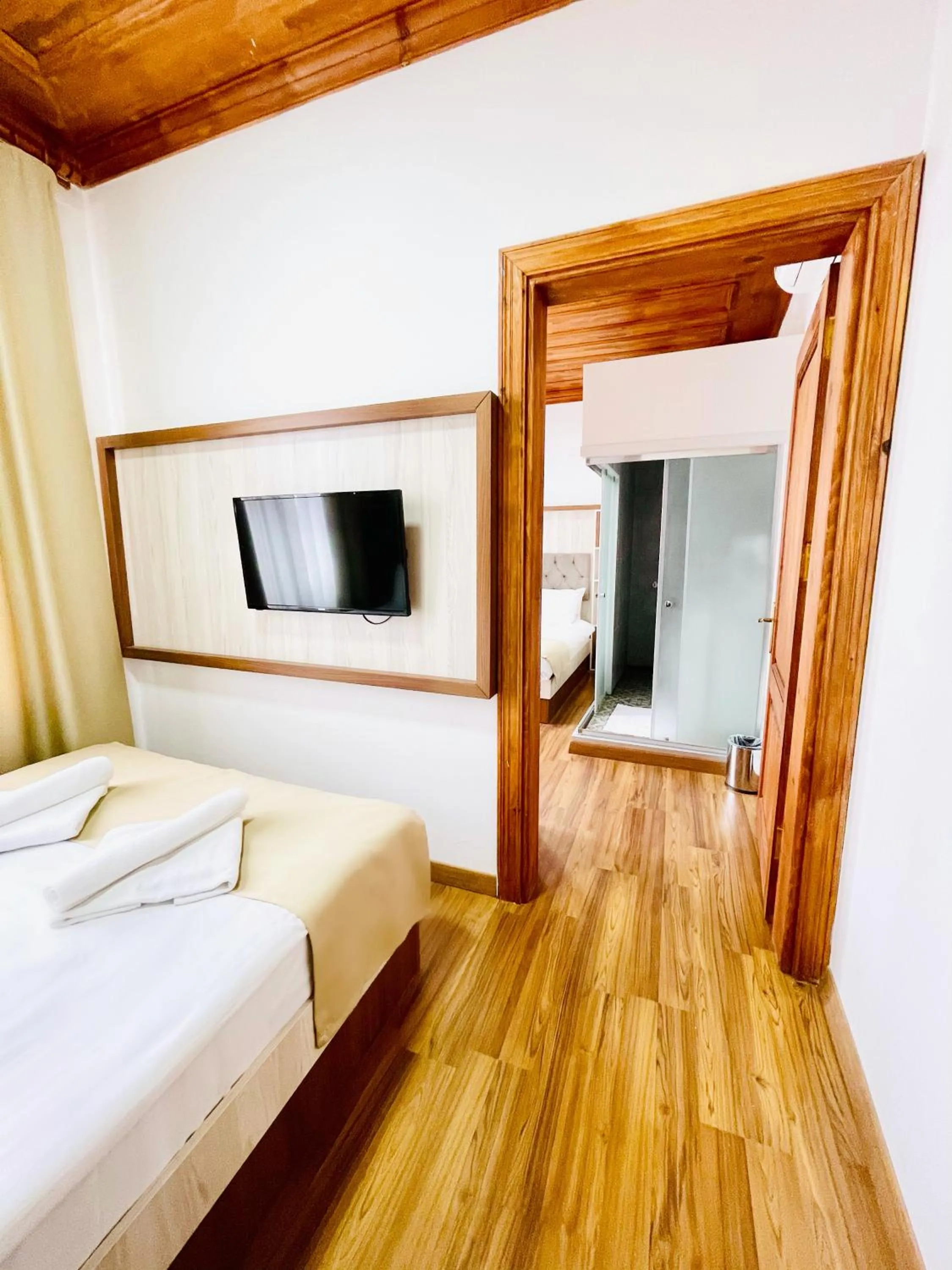 Bed in QONAQ HOTEL & SUITES