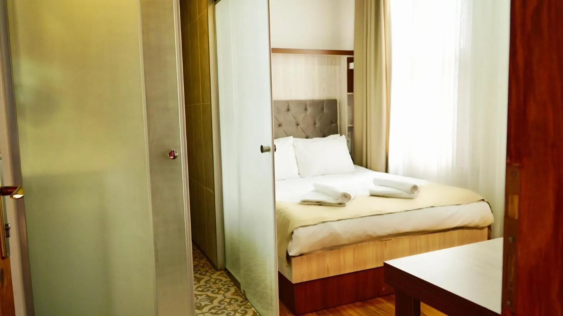 Bed in QONAQ HOTEL & SUITES