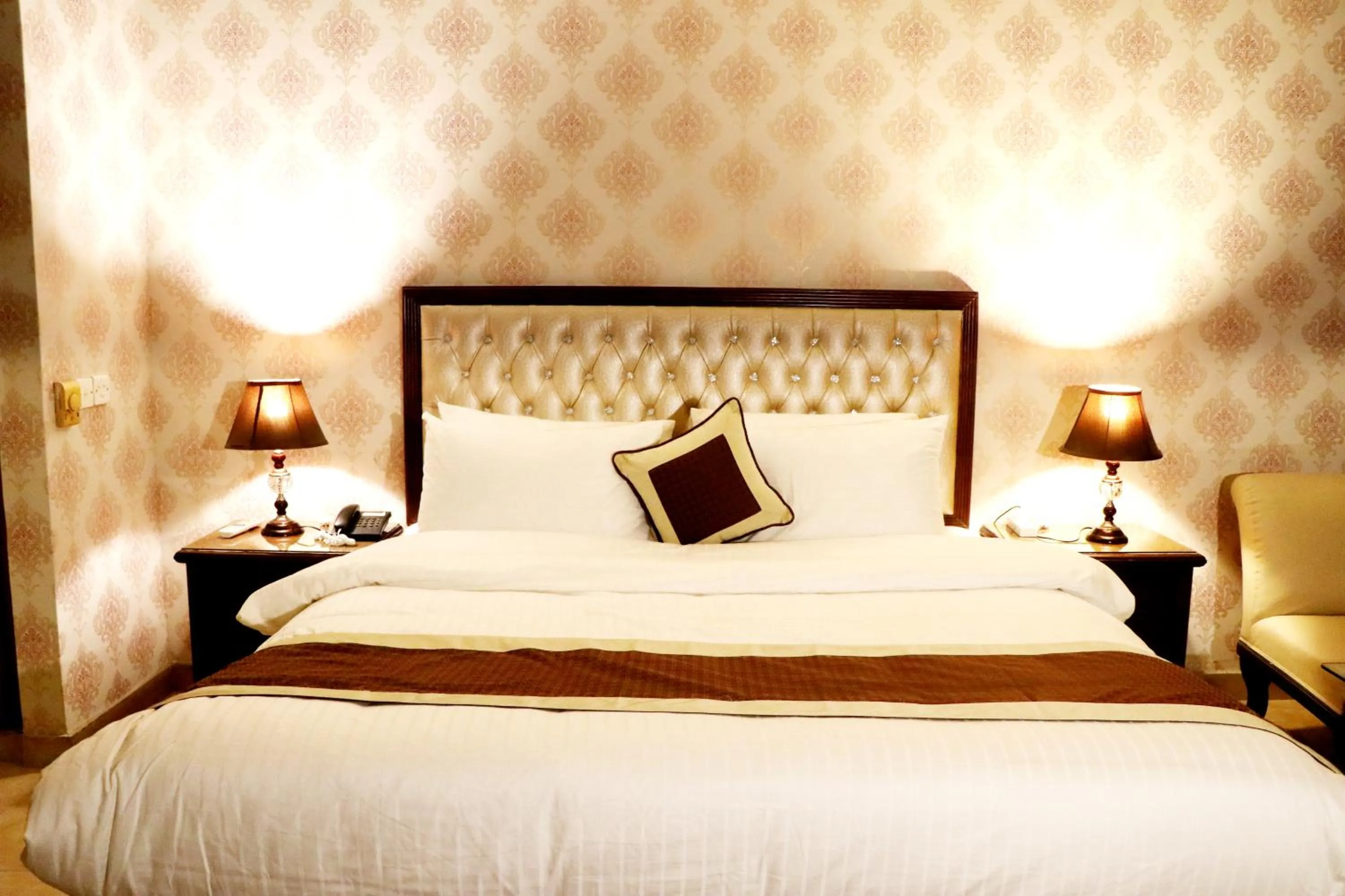 Bed in Shalimar Tower Hotel Lahore