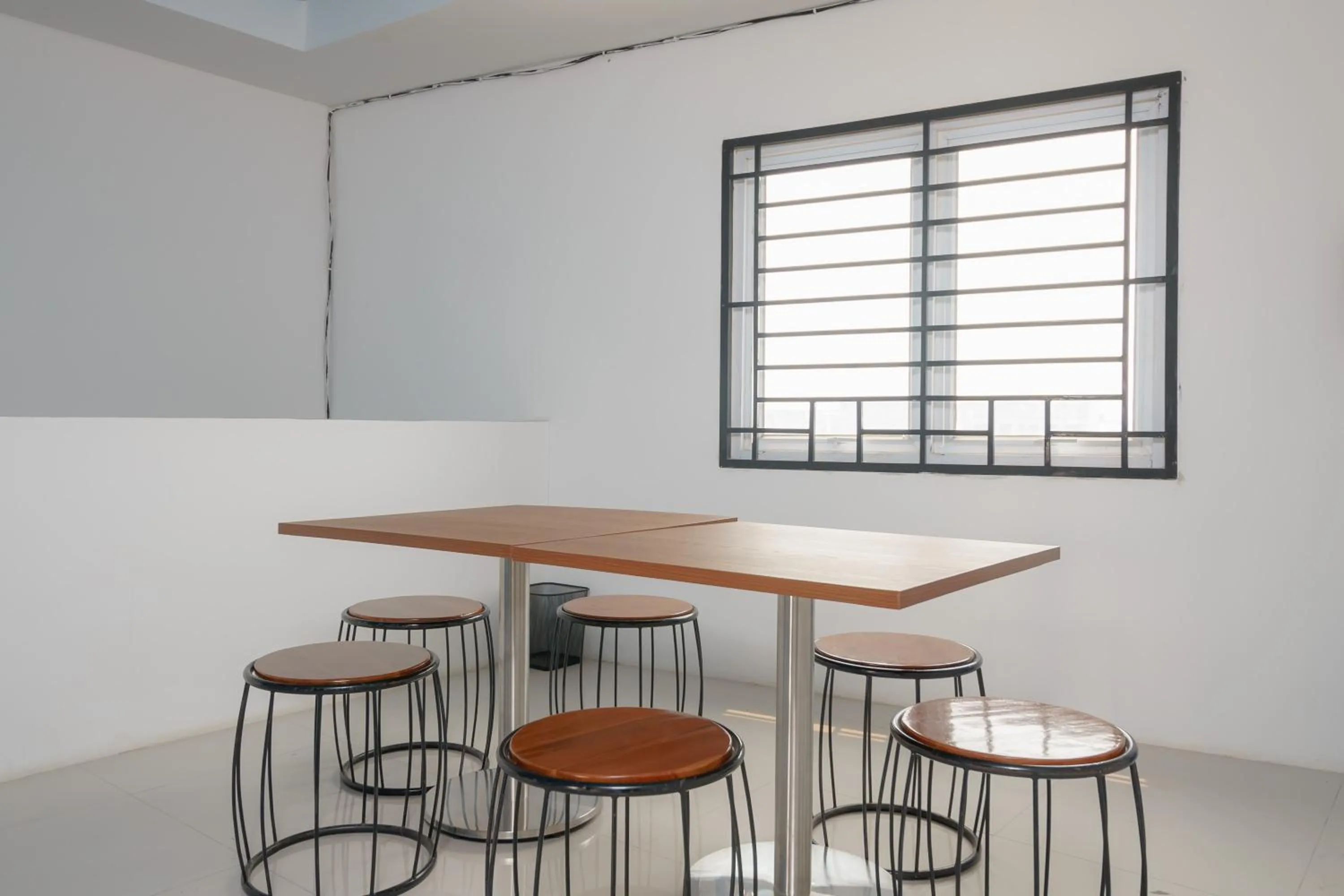 Seating area in RedDoorz Plus at Grand Tara Homestay Palembang