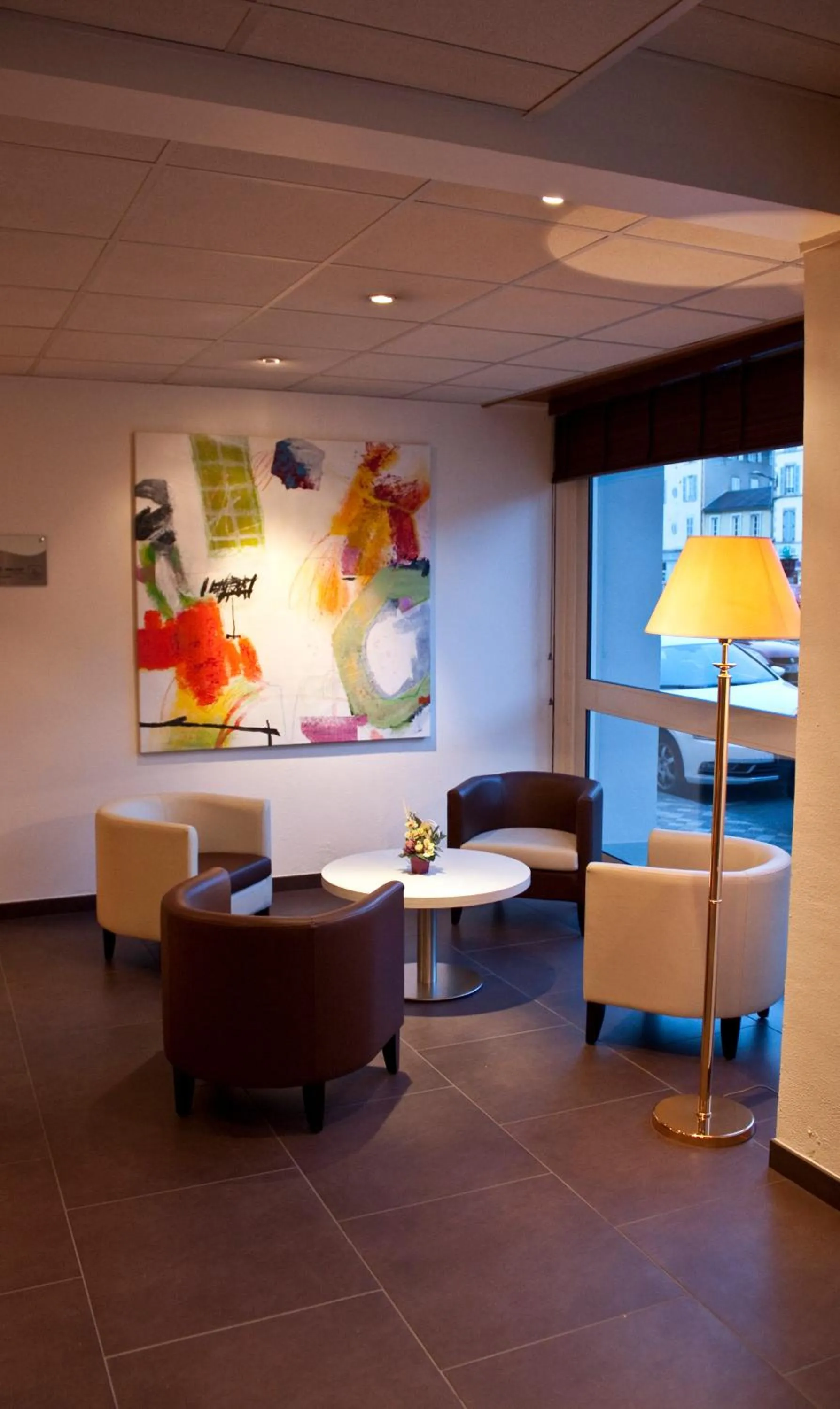 Communal lounge/ TV room in BRIT HOTEL Confort Le Limouzi TULLE