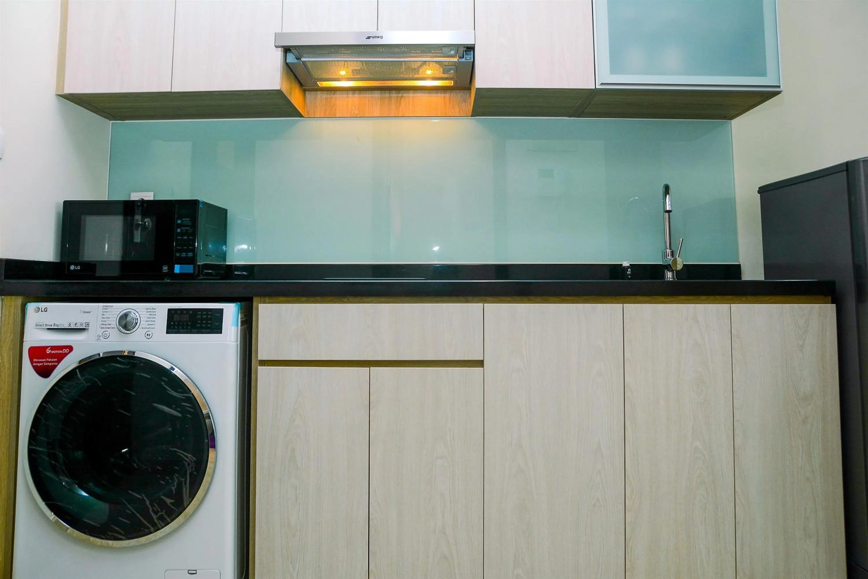 Kitchen or kitchenette in Modern and Cozy Studio Menteng Park Apartment By Travelio