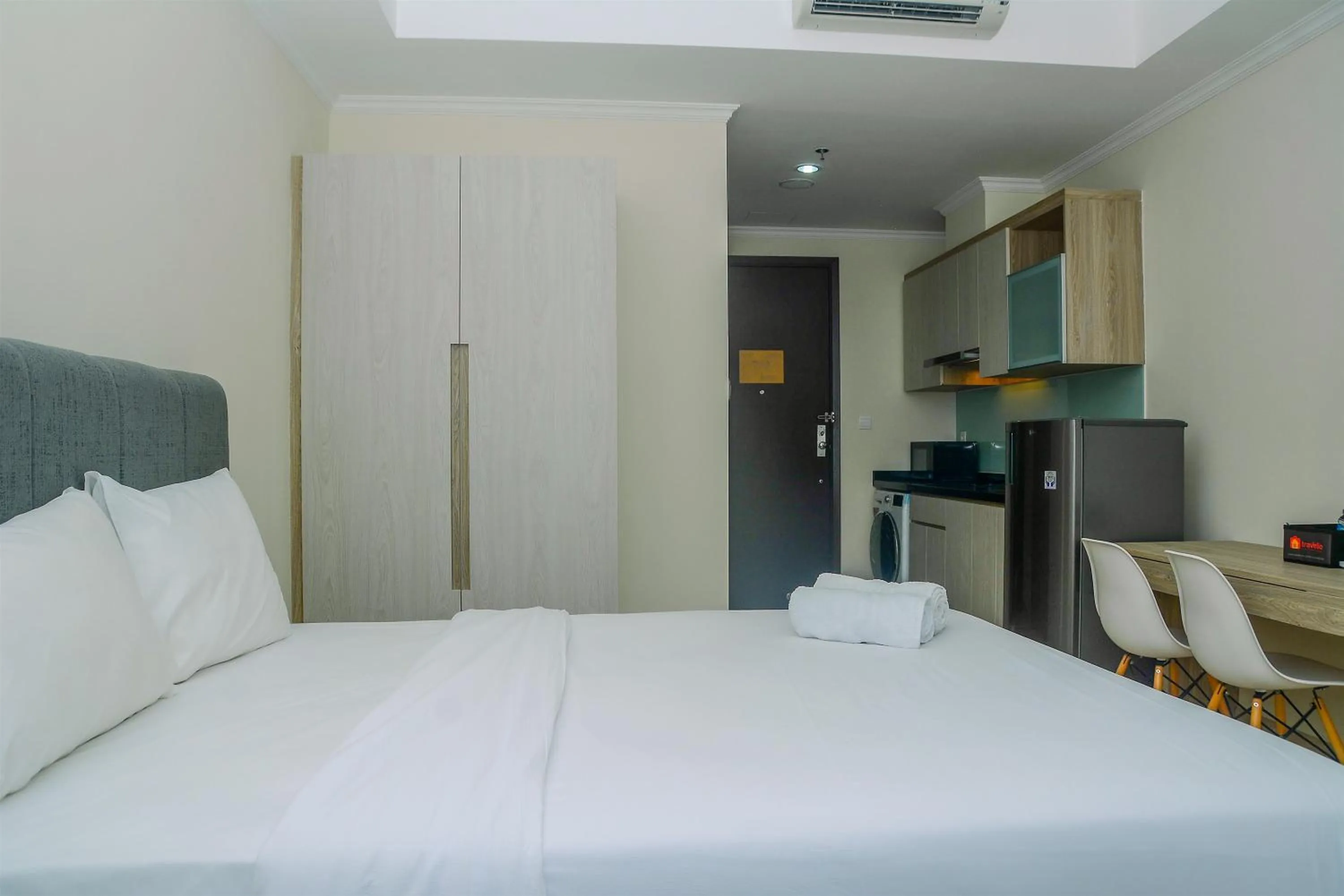 Bed in Modern and Cozy Studio Menteng Park Apartment By Travelio