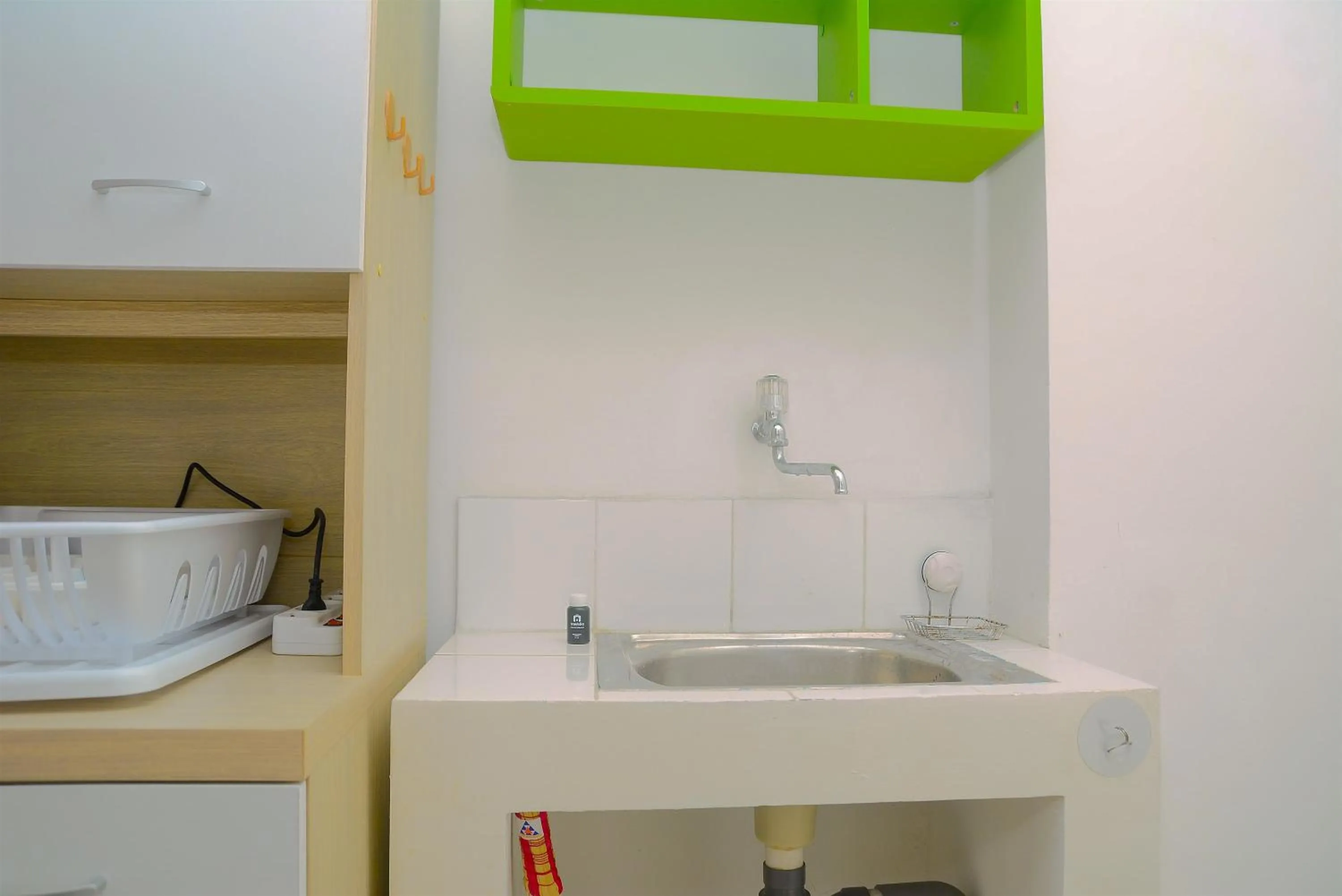 Kitchen or kitchenette in Green Bay Pluit Studio Apartment with 2 Single Beds By Travelio