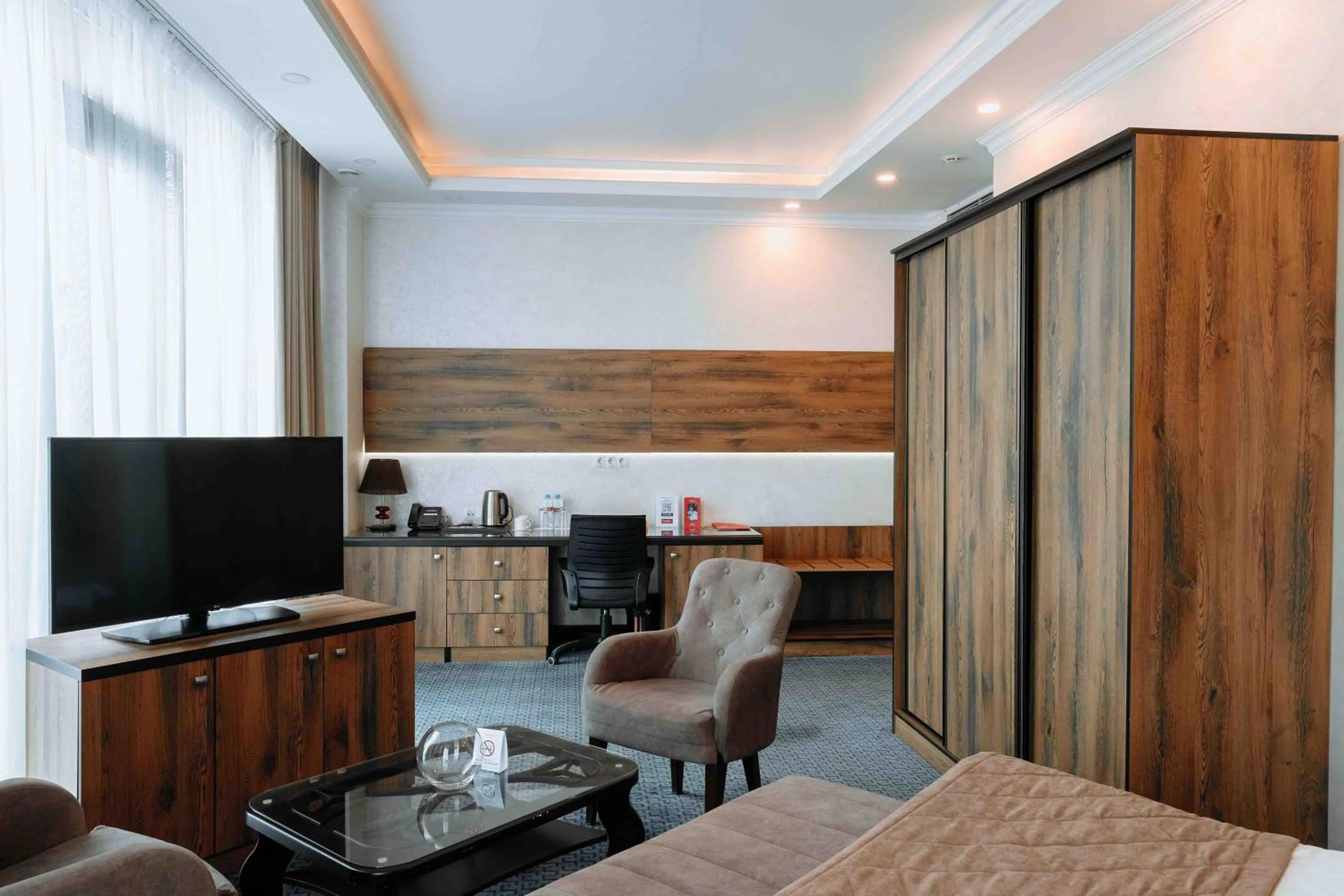 TV and multimedia in Ramada by Wyndham Shymkent