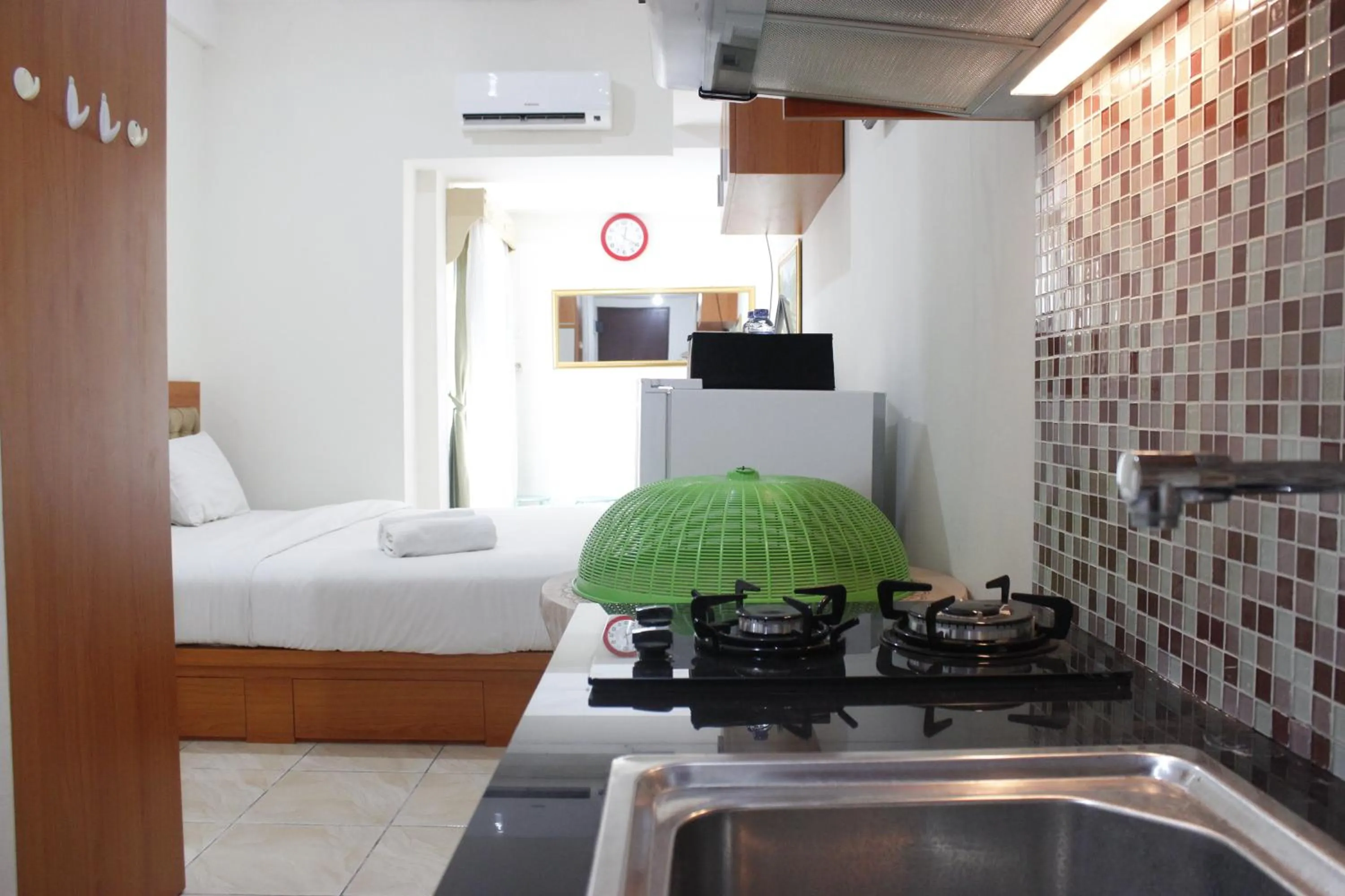 Bed in Compact Studio Tamansari Panoramic Apartment By Travelio