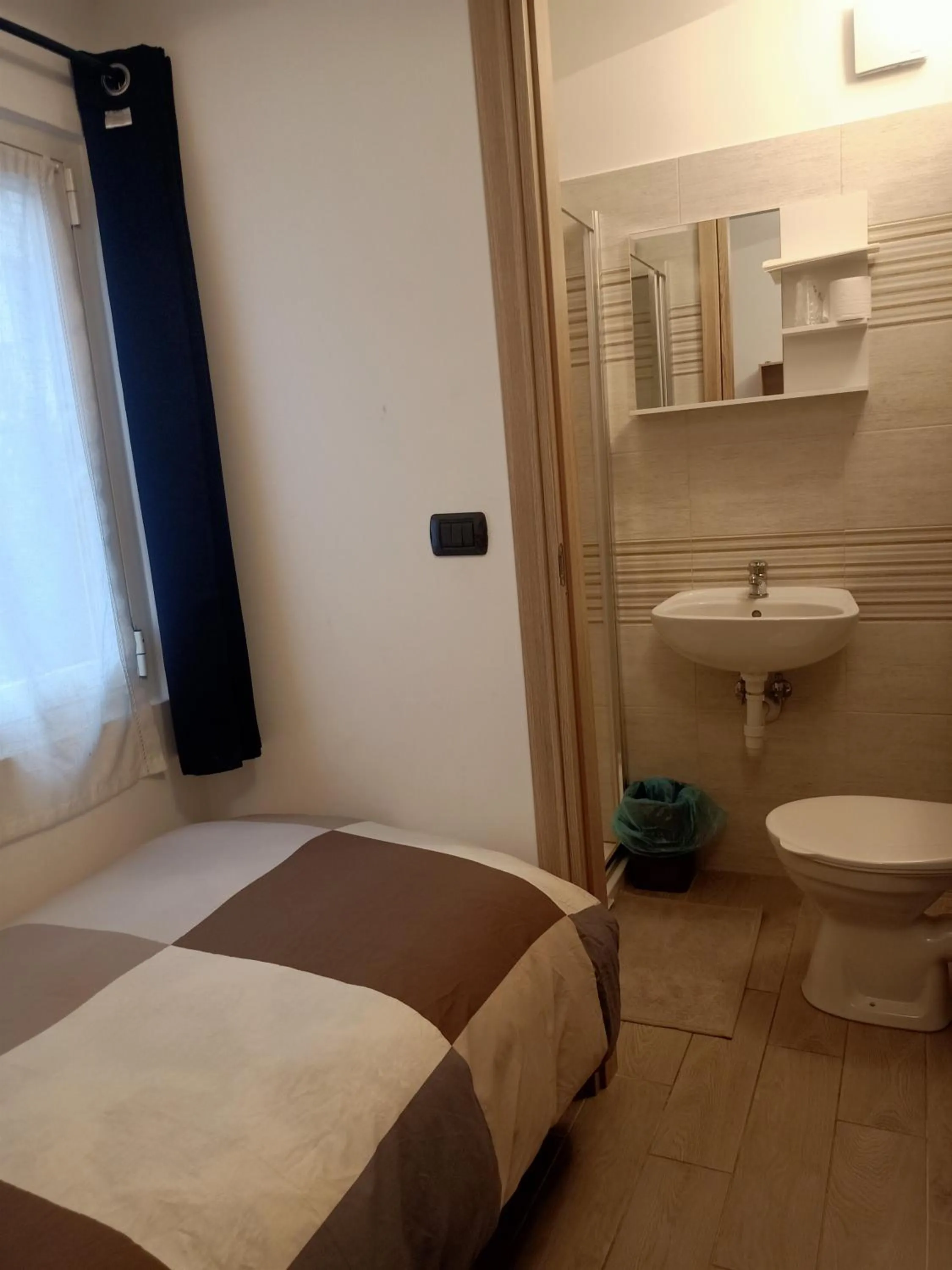 Toilet, Bed in Hotel Serena