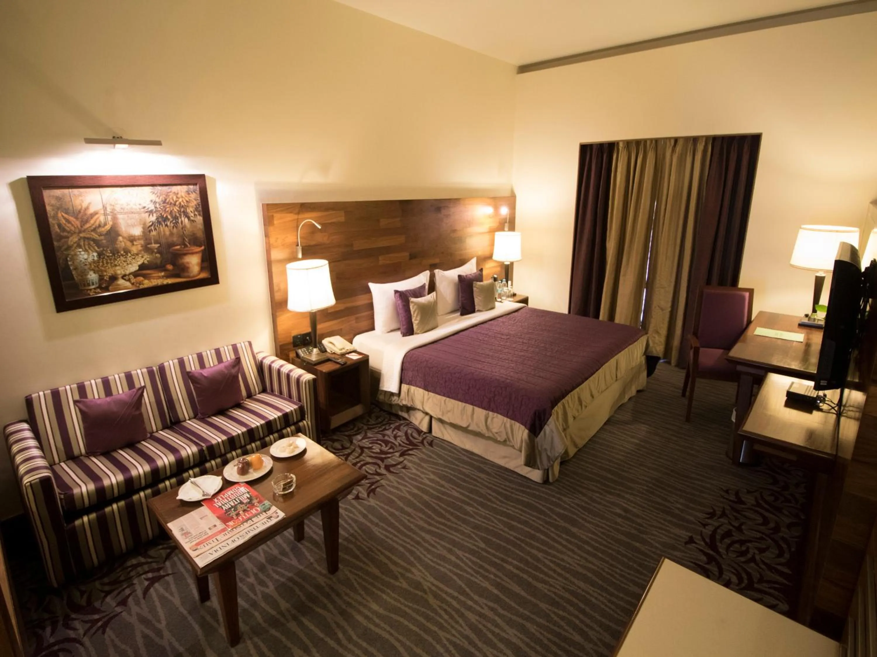 Seating area, Bed in The Orchid Hotel Hinjewadi Pune