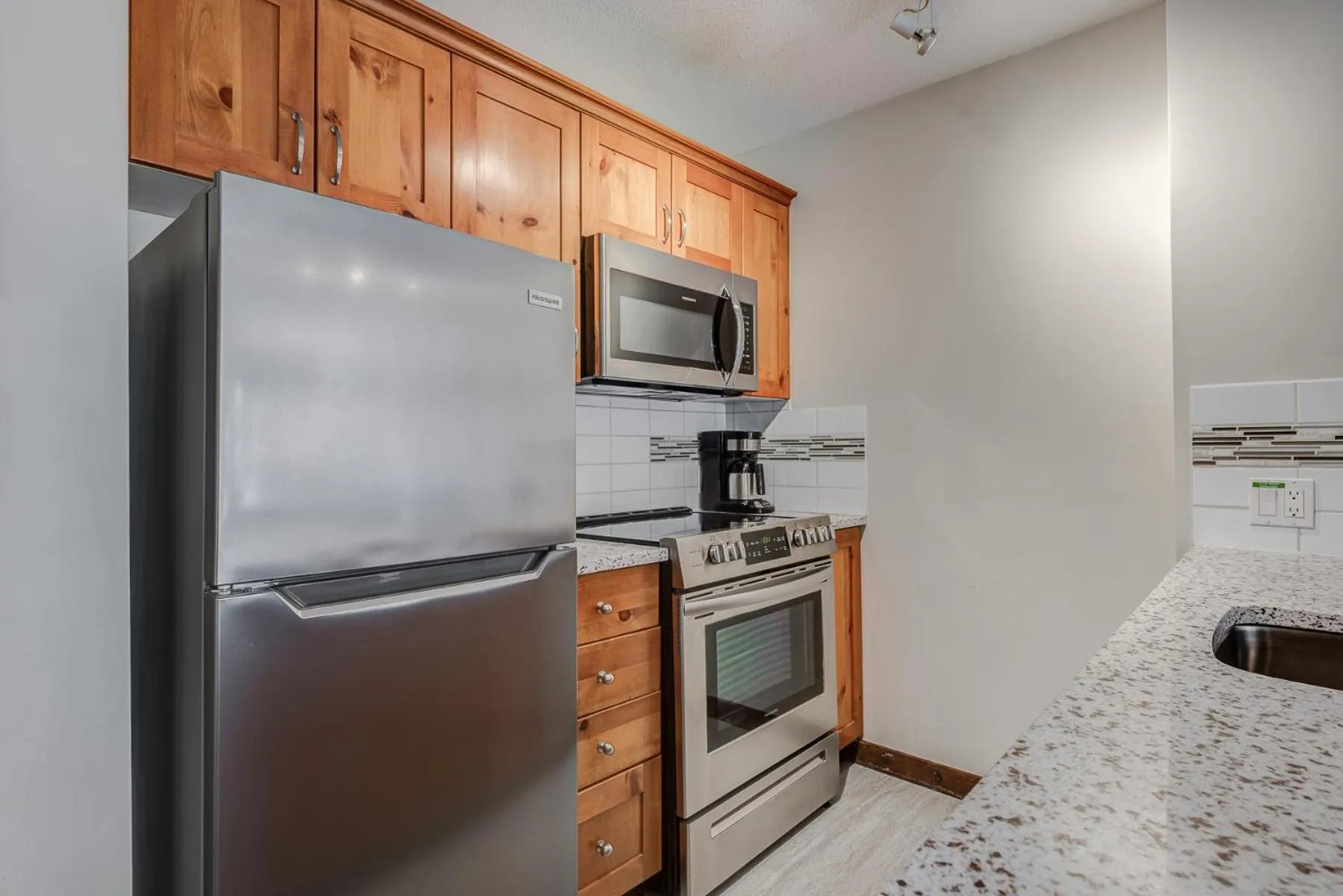 Kitchen or kitchenette in Blackcomb Springs Suites by CLIQUE