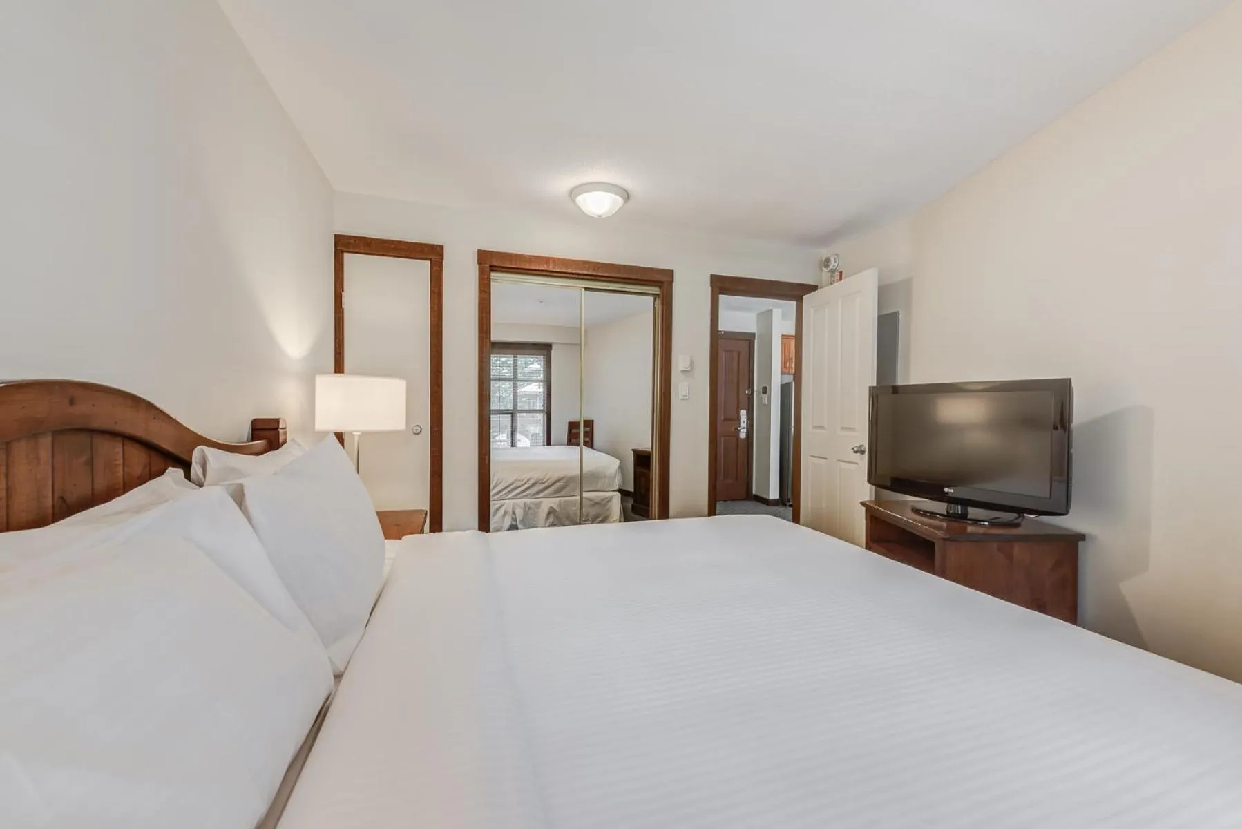 Bed in Blackcomb Springs Suites by CLIQUE