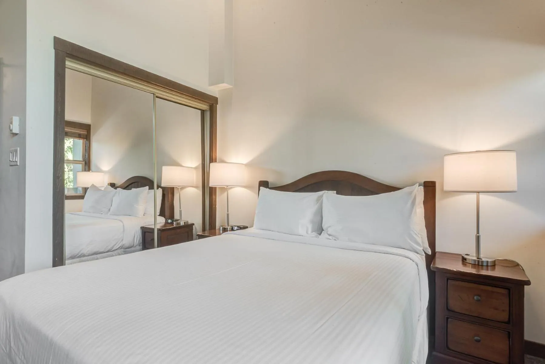 Bed in Blackcomb Springs Suites by CLIQUE