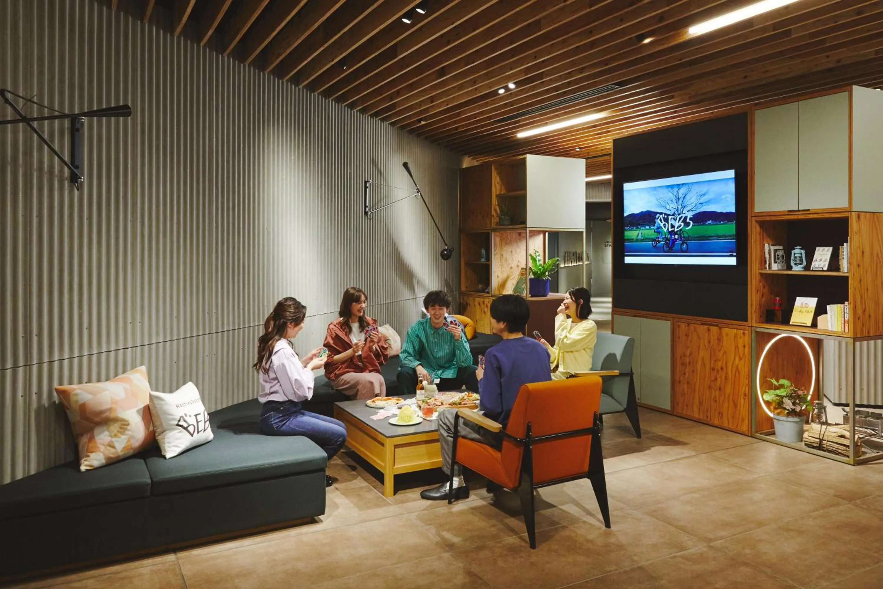 Communal lounge/ TV room in BEB5 Tsuchiura by Hoshino Resorts