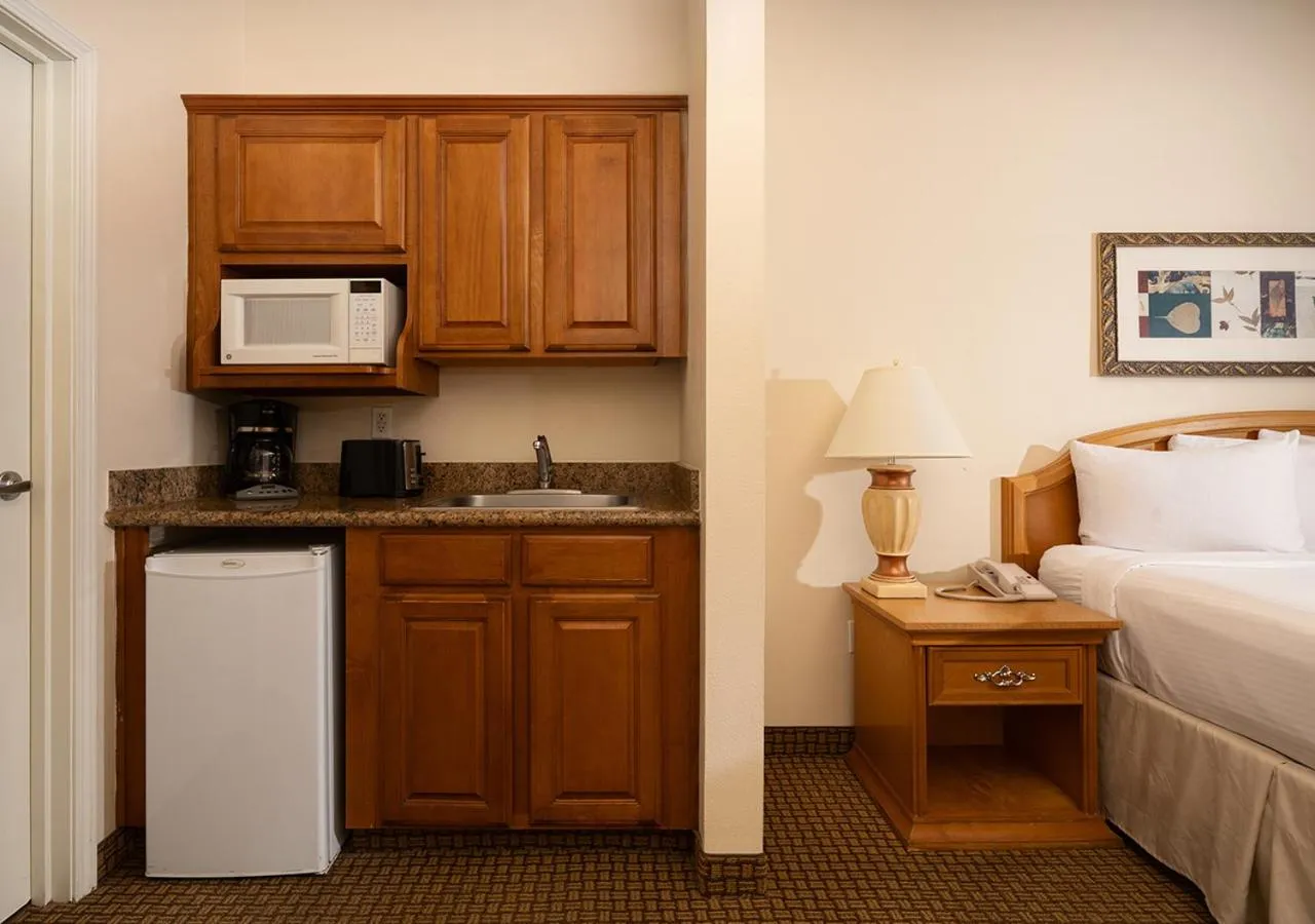 Kitchen or kitchenette, Bed in Club de Soleil All-Suite Resort