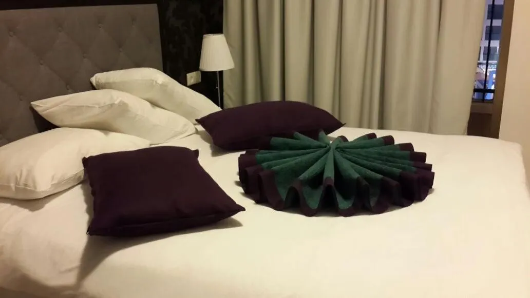 Bed in Kikar Boutique Hotel
