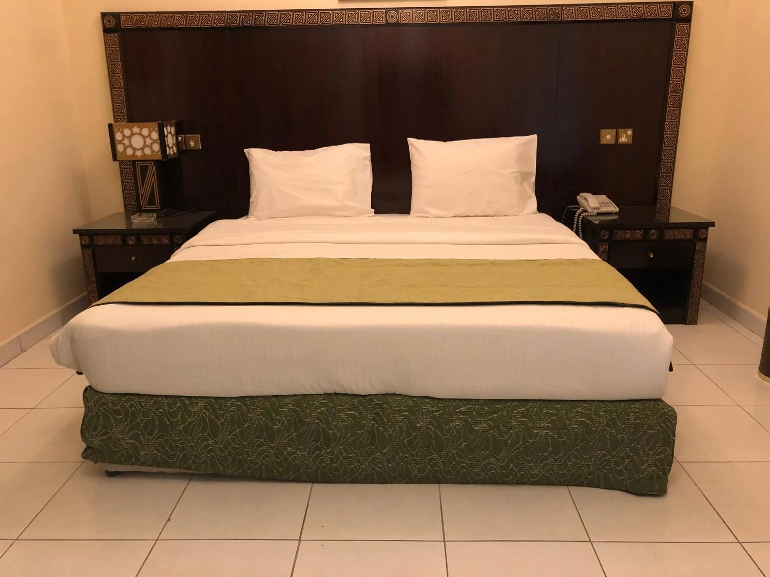 Bed in New Royal Mark Hotel Apartments