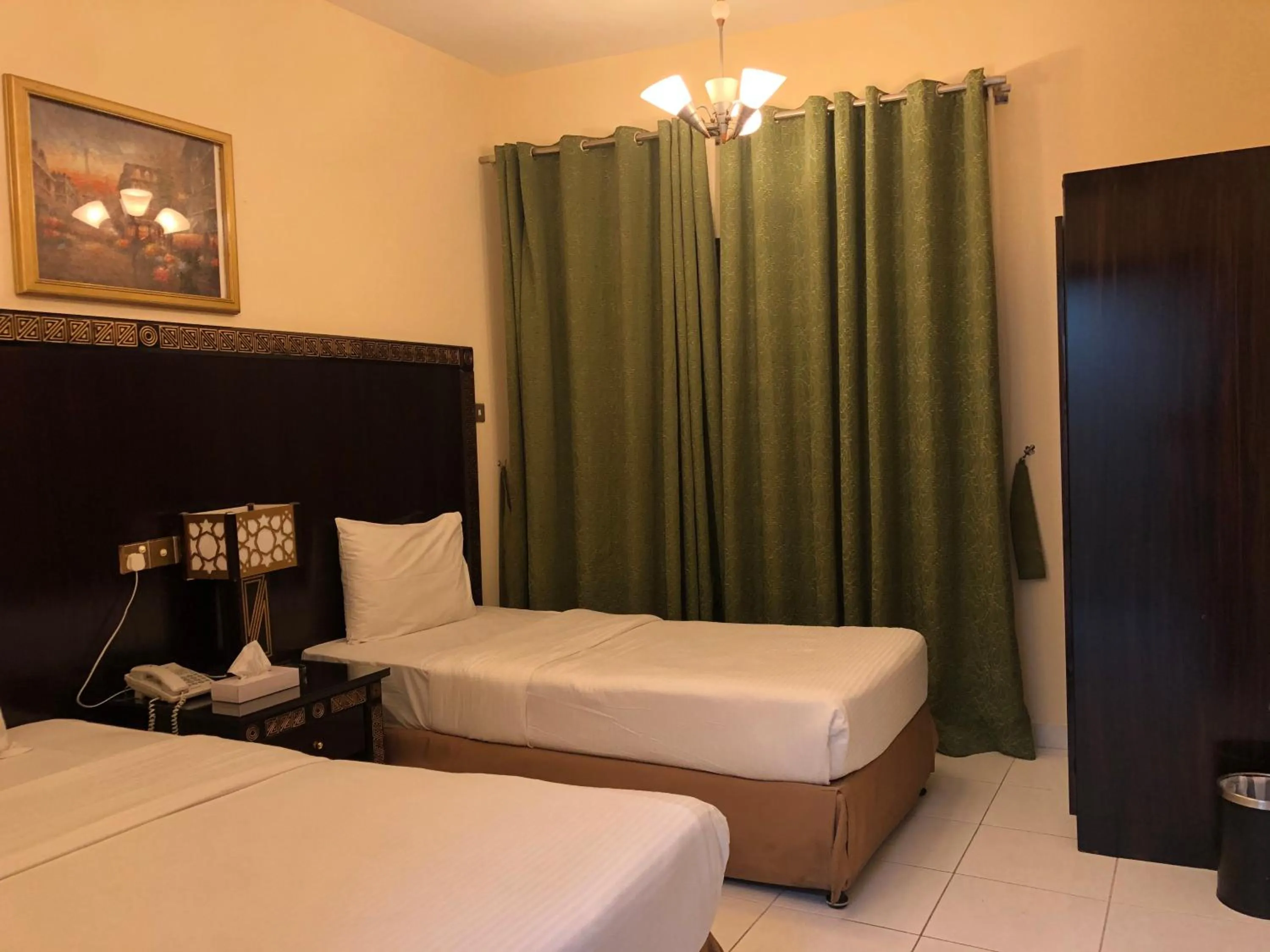 Bed in New Royal Mark Hotel Apartments